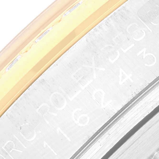 This image shows a close-up of the engraved rehaut and part of the bezel on a Rolex Datejust 116243 Men's Stainless Steel Silver Dial 116243 Men's Stainless Steel Silver Dial watch.