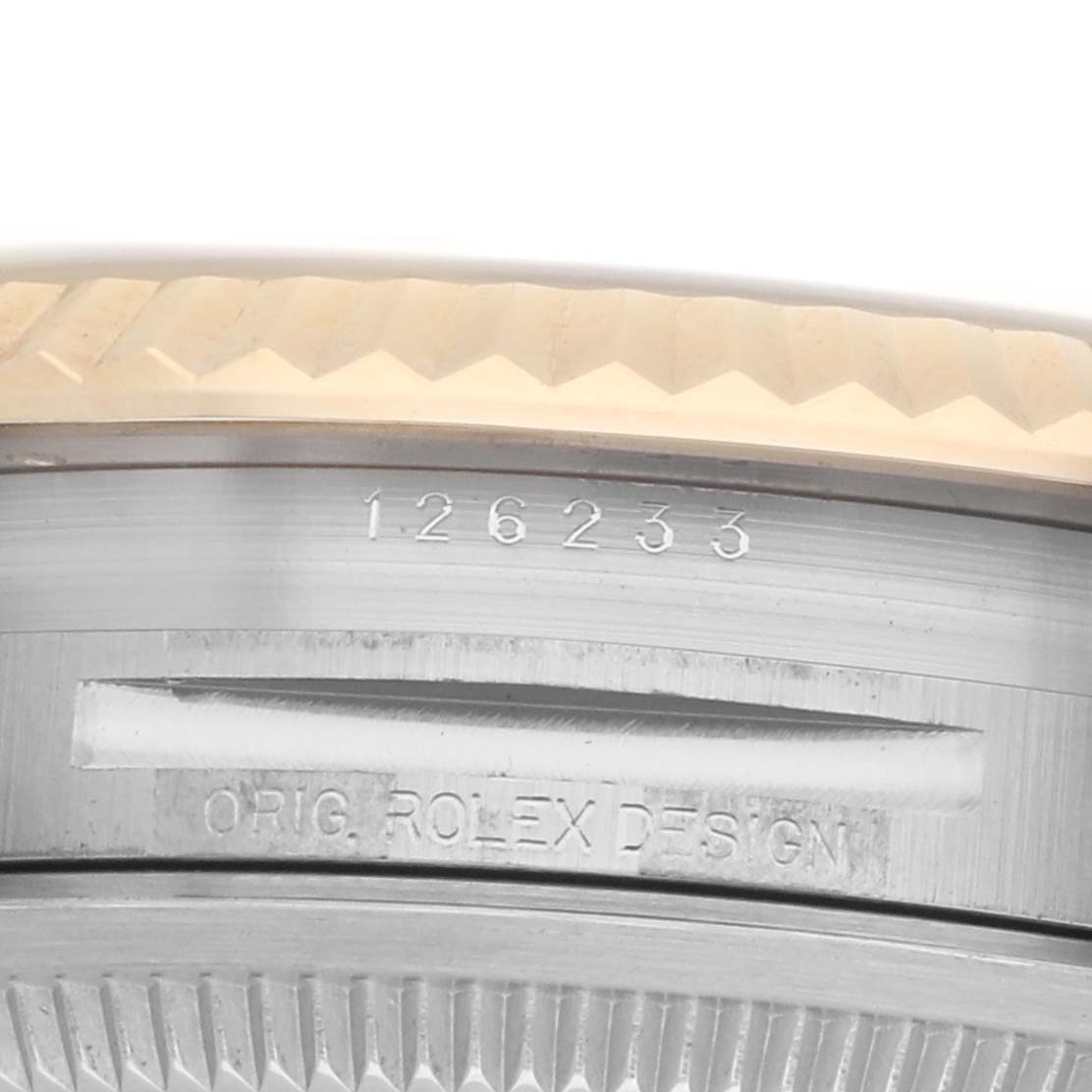 The image shows a close-up of the case side with the fluted bezel of a Rolex Datejust 126233 Men's Steel and Gold (two tone) Champagne Dial, featuring engravings with the model number.