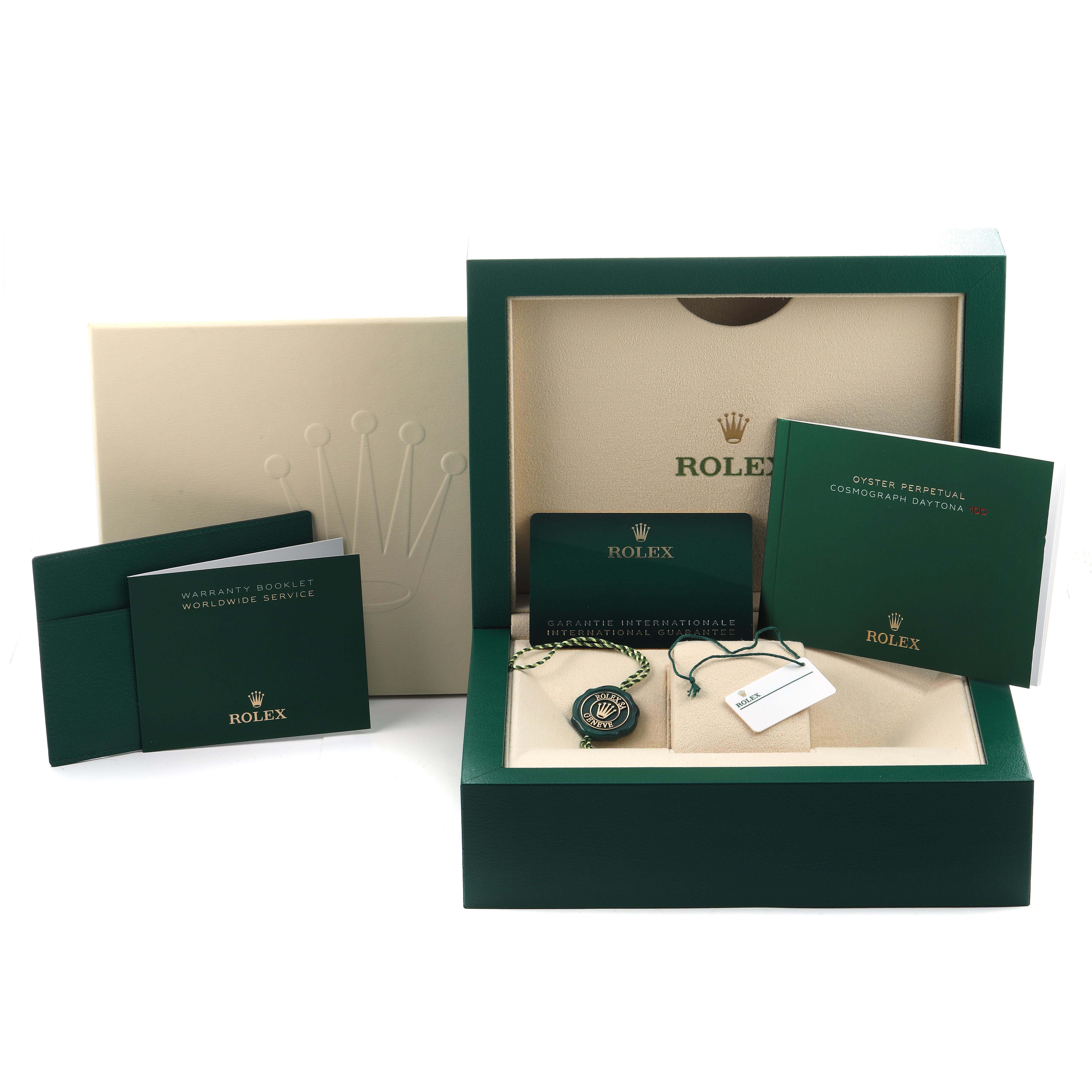The image shows a Rolex Daytona 126529LN Men's White Gold Black Dial packaging with booklets, tags, and a warranty card in a display box.