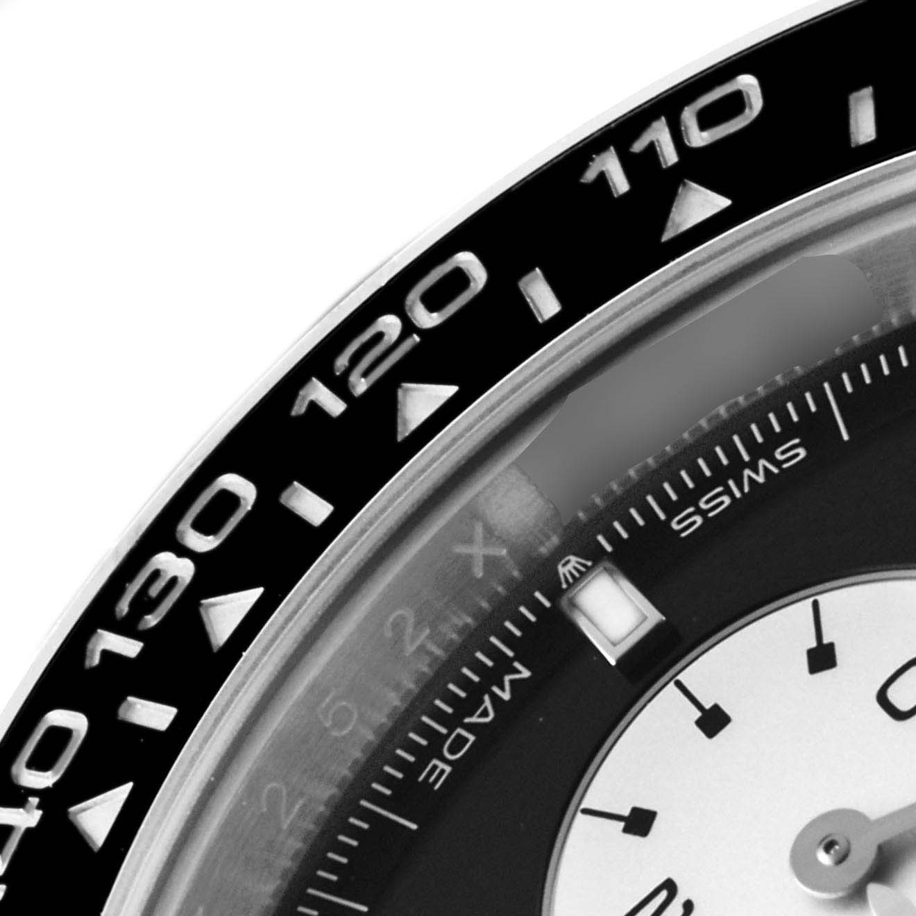 The image shows a close-up of the bezel and partial dial of a Rolex Daytona 126529LN Men's White Gold Black Dial, highlighting the tachymetric scale.