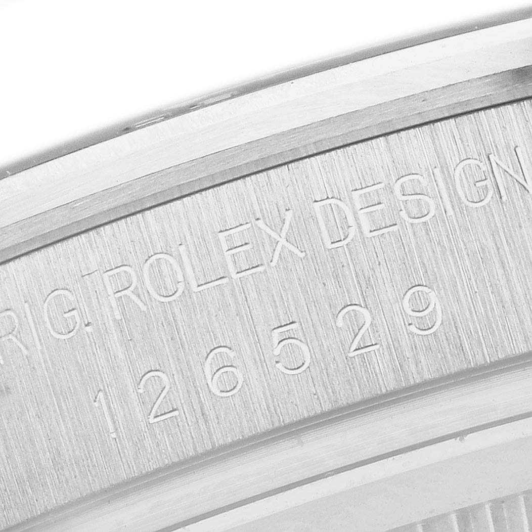 The image shows a close-up of the side engraving on the case of a Rolex Daytona 126529LN Men's White Gold Black Dial watch, featuring the model number.