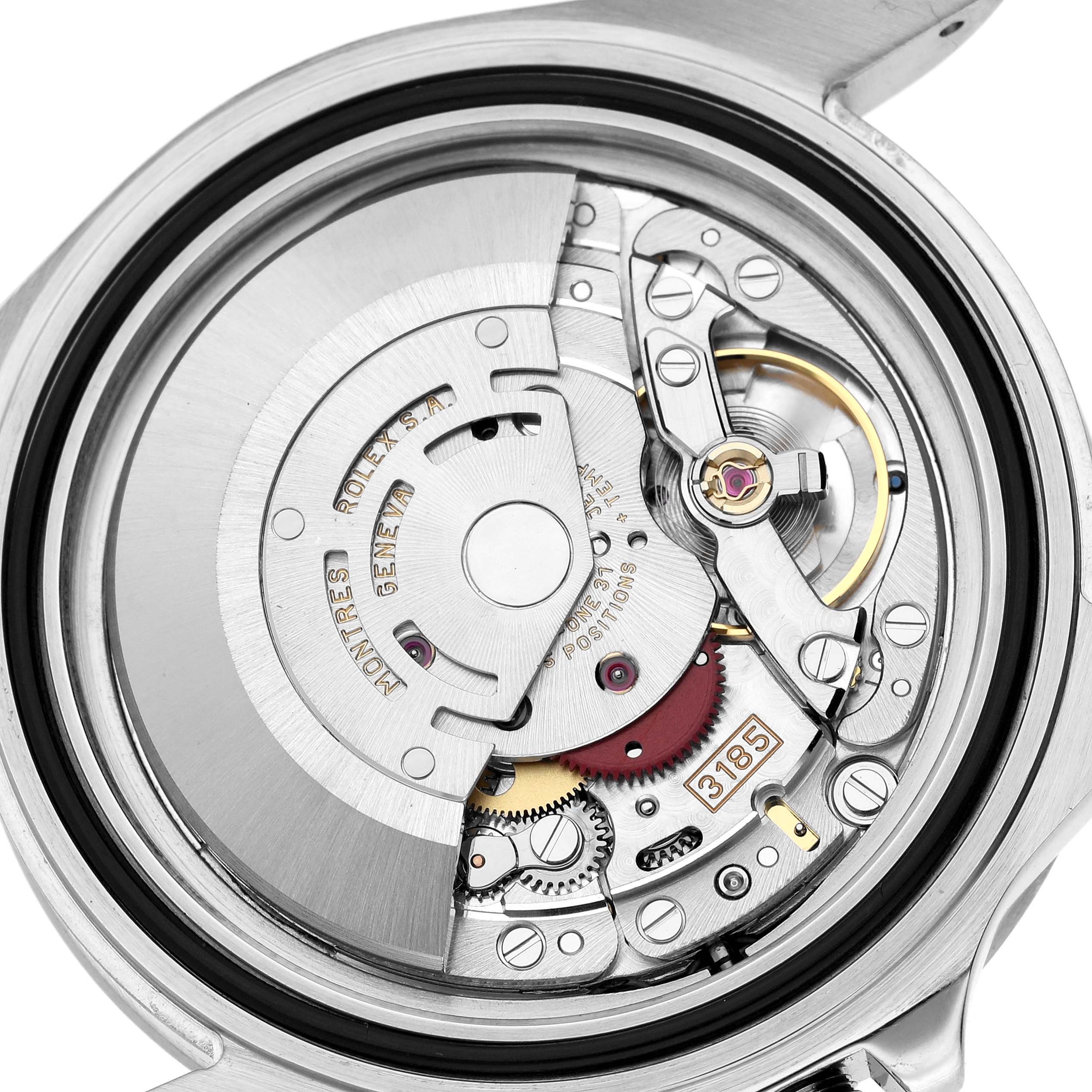 The image shows the internal movement of a Rolex Explorer 16570 Men's Stainless Steel Black Dial watch from the back, highlighting gears and components.