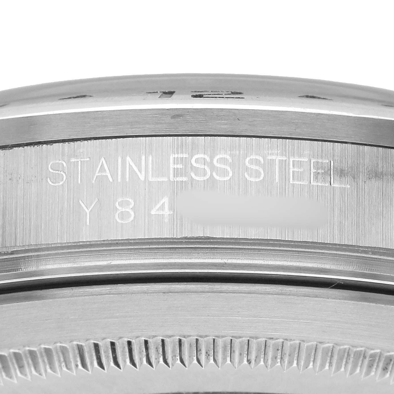 The image shows a close-up of the case edge and bezel of a Rolex Explorer 16570 Men's Stainless Steel Black Dial, highlighting the "STAINLESS STEEL" engraving.