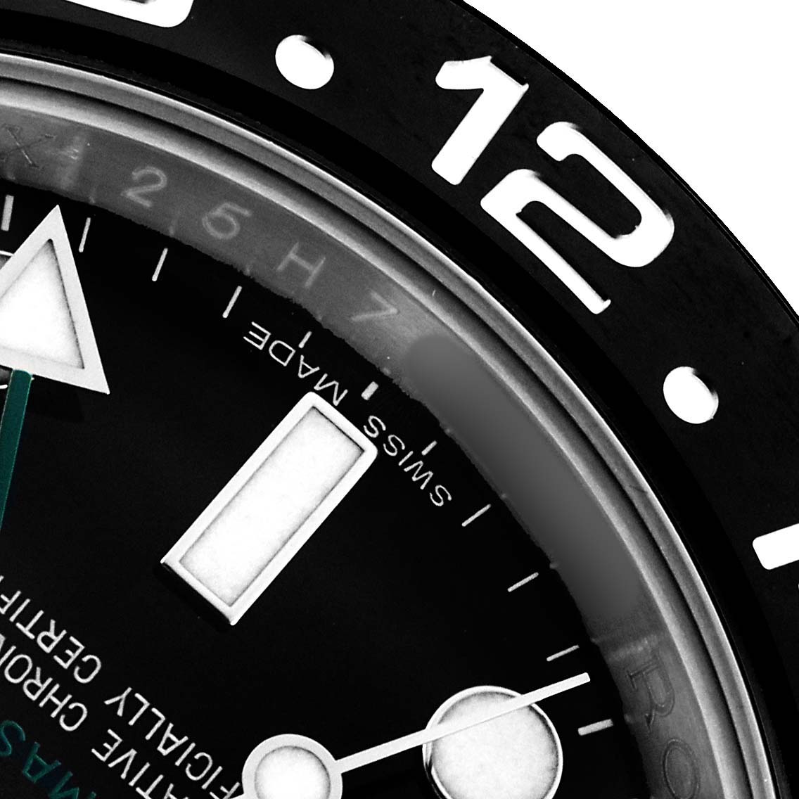 The image shows a close-up of the bezel and part of the dial of a Rolex GMT-Master 116710 Men's Stainless Steel Black Dial watch, highlighting the "12" marker and Swiss Made text.