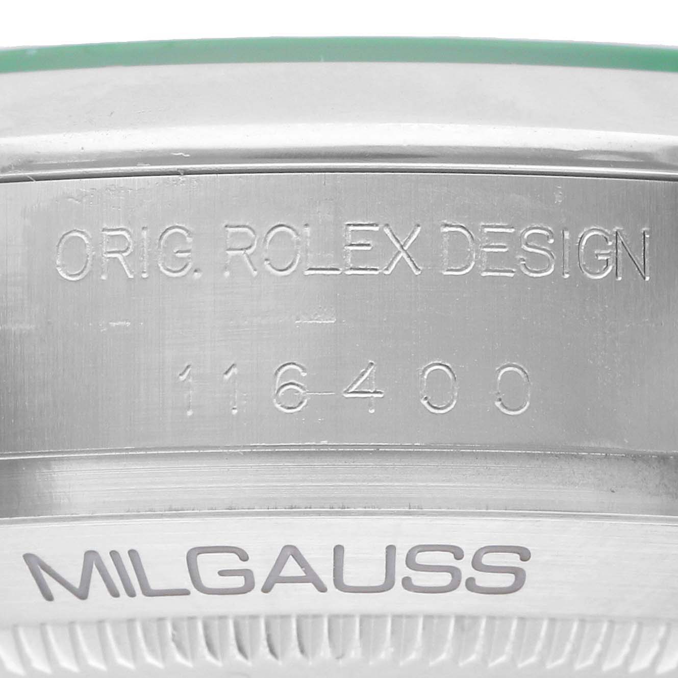 The image shows a close-up of the side of a Rolex Milgauss 116400GV Men's Stainless Steel Blue Dial watch, highlighting engravings on the metal case.