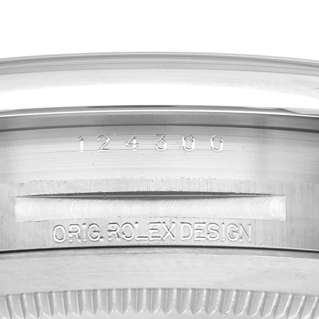 The image shows a close-up of the inner bezel engraving on a Rolex Oyster Perpetual 124300 Men's Stainless Steel Blue Dial 124300 Men's Stainless Steel Blue Dial watch, displaying model details.