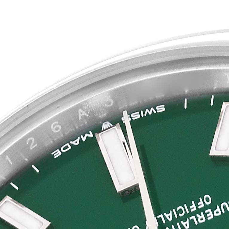 This image shows a close-up of the bezel, markers, and part of the dial of a Rolex Mid-Size 277200 Women's Stainless Steel Green Dial 277200 Women's Stainless Steel Green Dial model watch.