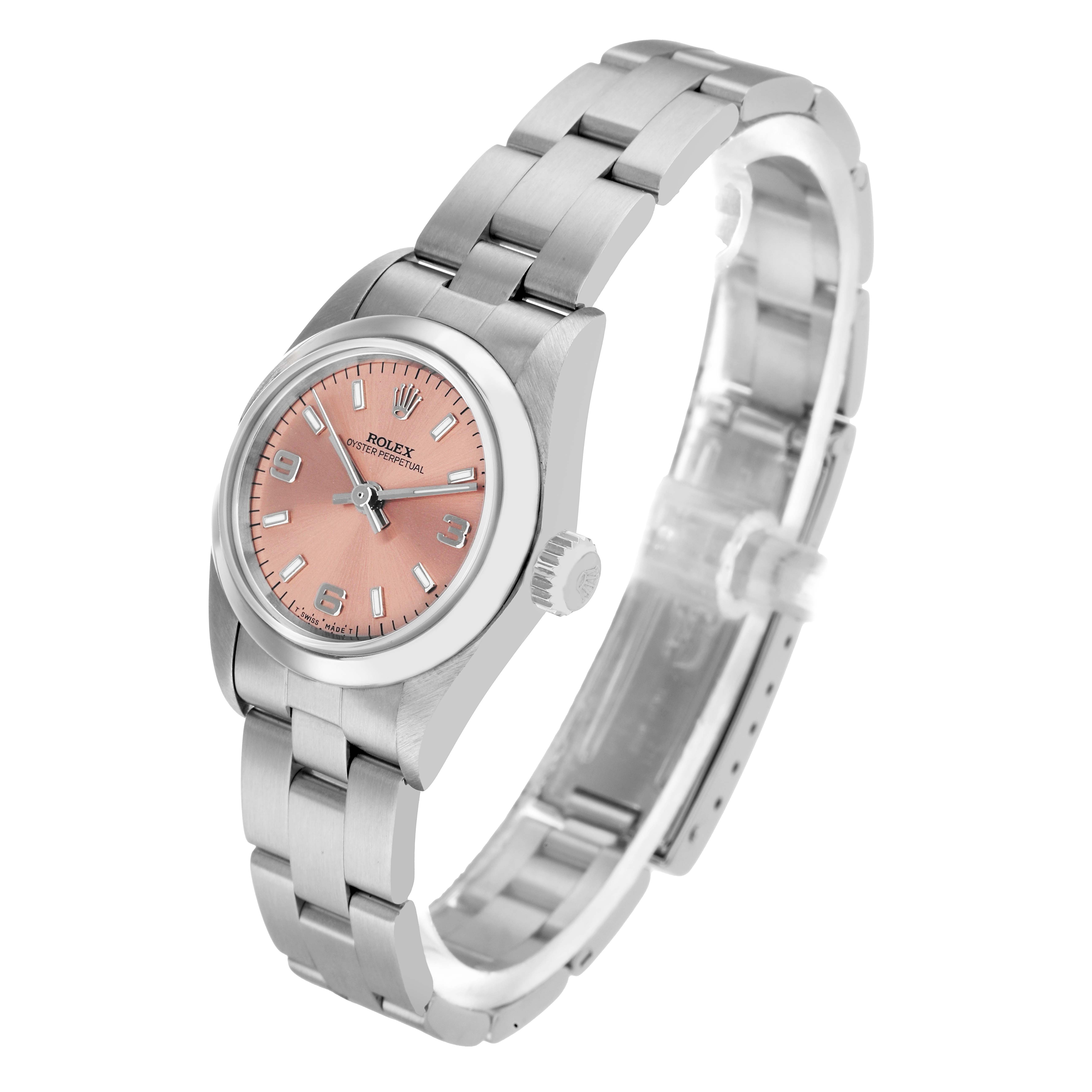 The Rolex Oyster Perpetual 67180 Women's Stainless Steel Pink Dial watch is shown at an angled view, displaying the pink dial, crown, case, and metal bracelet.