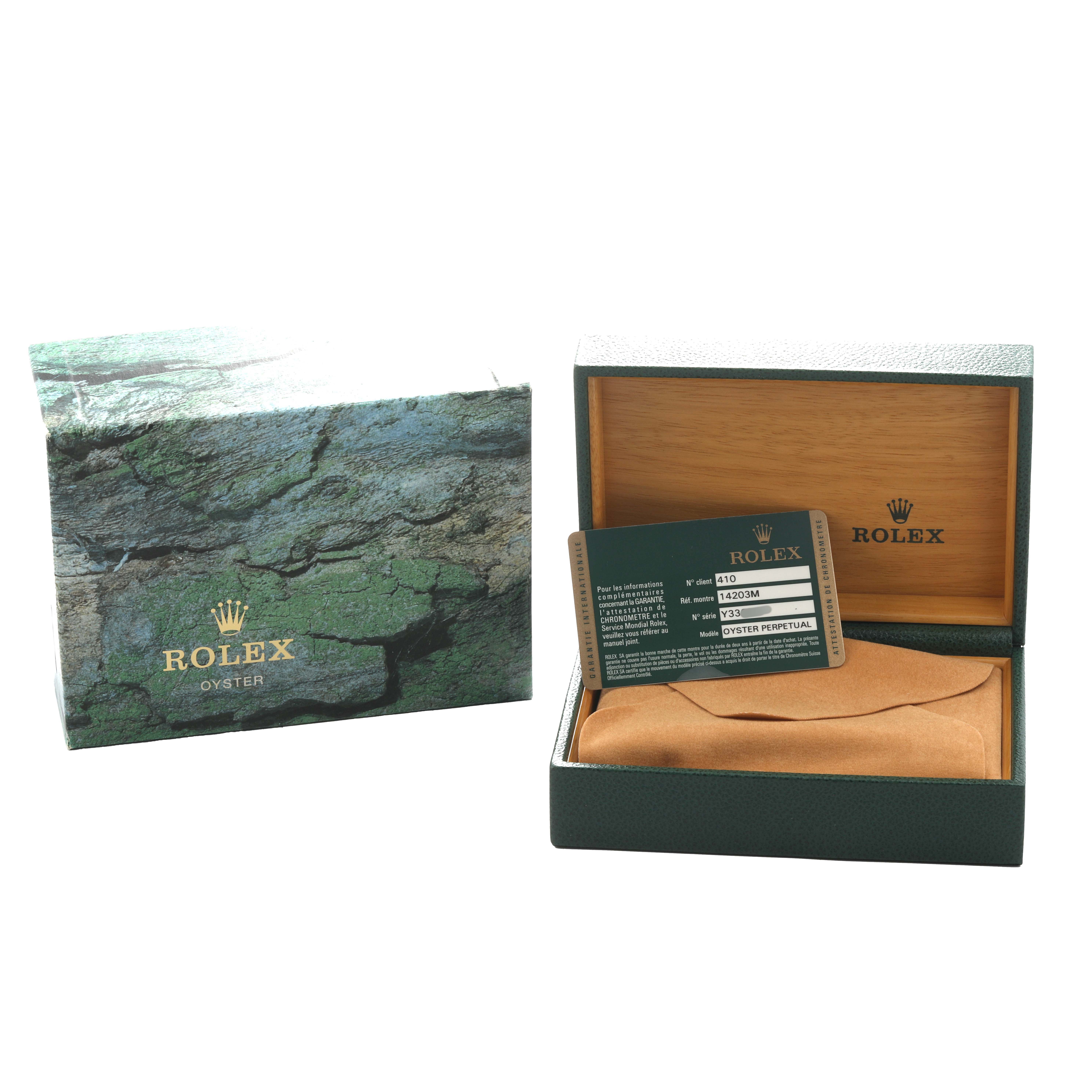 The image shows the packaging and accessories for a Rolex Oyster Perpetual 14203 Men's Steel and Gold (two tone) Black Dial, featuring a box, warranty card, and protective pouch.