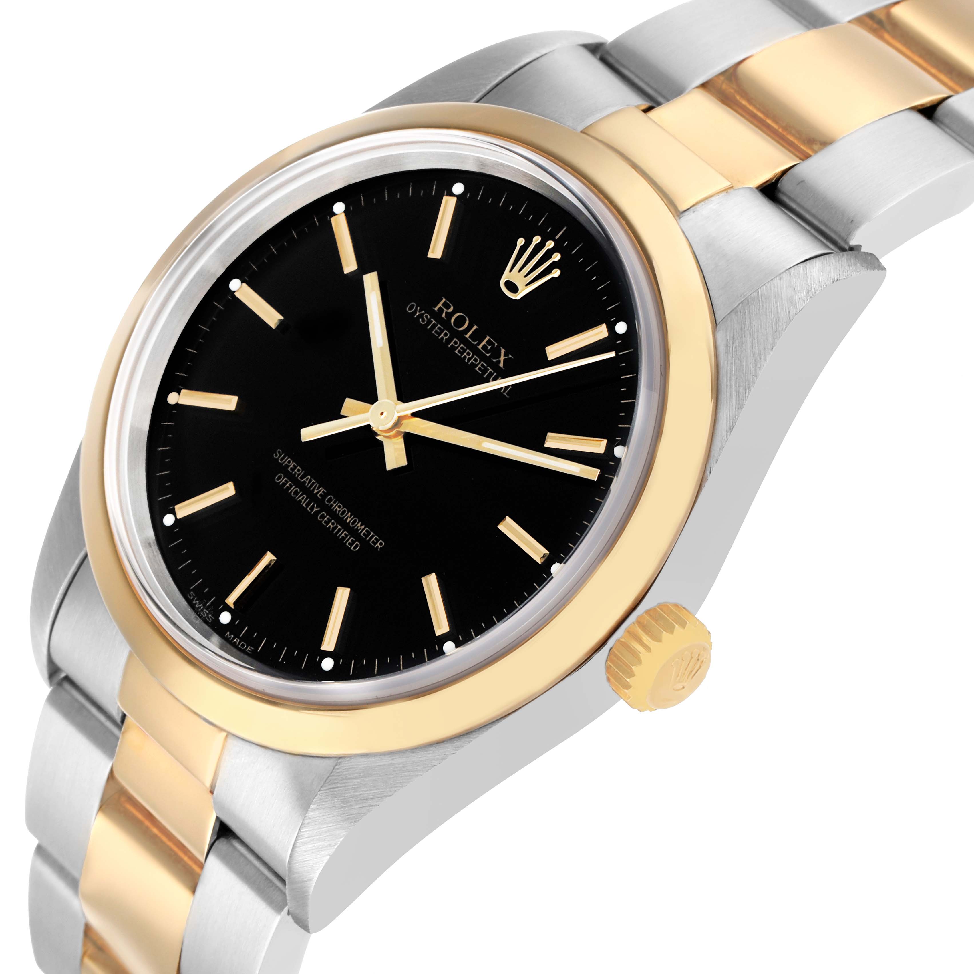 The Rolex Oyster Perpetual 14203 Men's Steel and Gold (two tone) Black Dial watch is shown at an angle highlighting the black dial, gold case, and part of the two-tone bracelet.