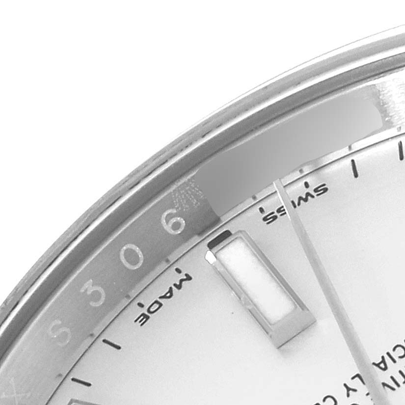 The image shows a close-up angle of the dial and bezel of a Rolex Oyster Perpetual 114200 Men's Stainless Steel White Dial 114200 Men's Stainless Steel White Dial watch, focusing on the 6 o'clock marker.