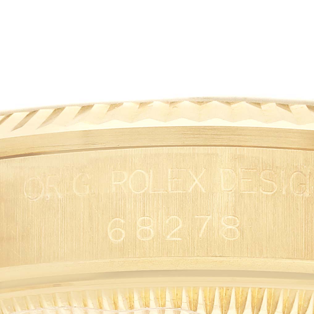 The image shows a close-up side view of the Rolex President 68278 Women's Yellow Gold Silver Dial model, focusing on the engraved bezel and case edge.