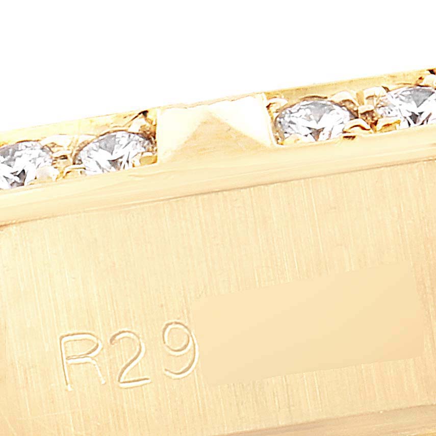 This close-up image shows part of the gold band and embedded diamonds of a Rolex President 69258 Women
s Yellow Gold Champagne Dial 69258 Women
s Yellow Gold Champagne Dial model watch.
