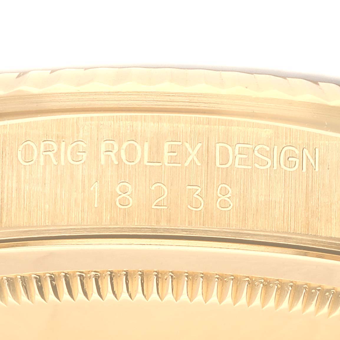 The image shows a close-up of the side of a Rolex President 18238 Men's Yellow Gold Black Dial 18238 Men's Yellow Gold Black Dial model watch, displaying the engraving "ORIG ROLEX DESIGN 18238".