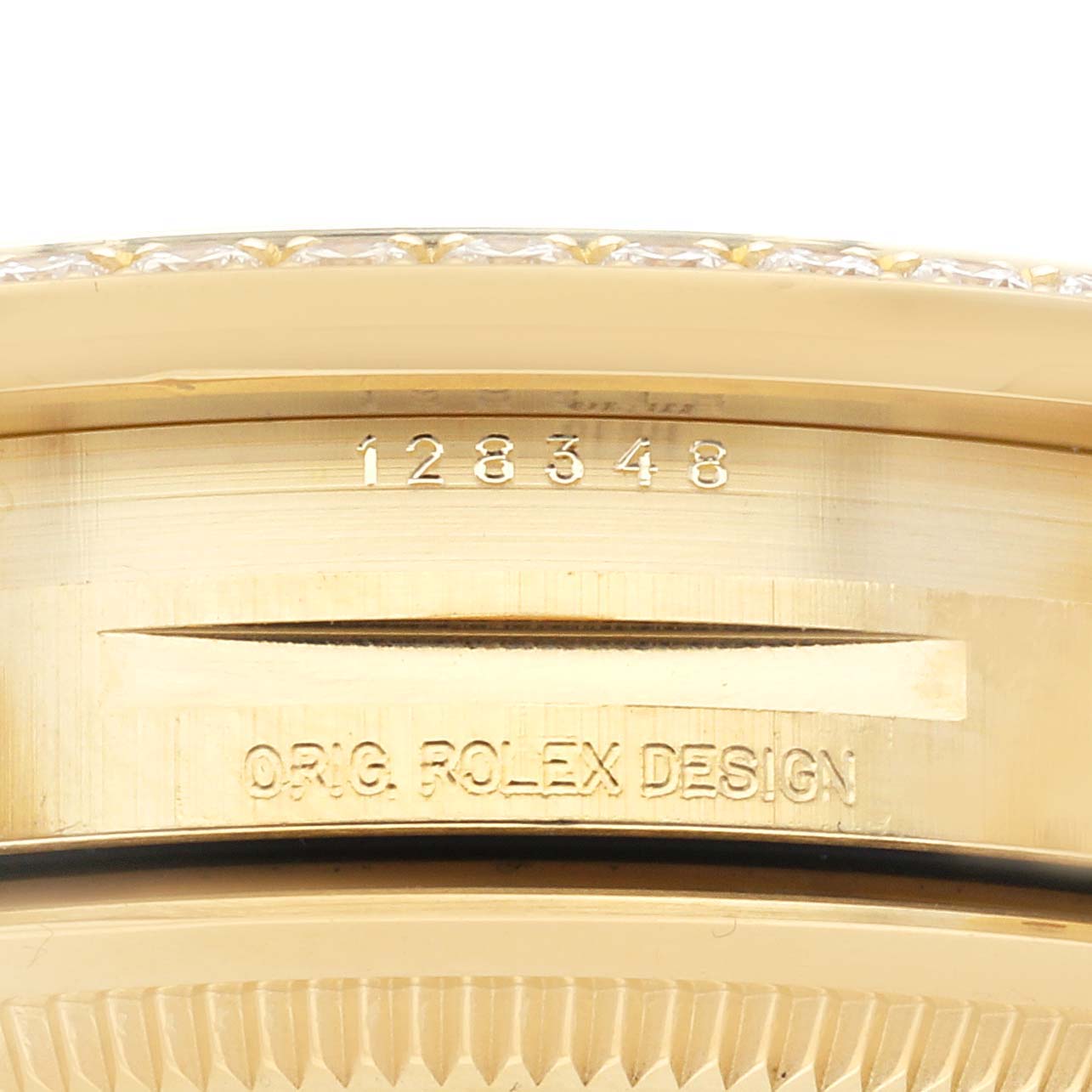 The image shows a close-up of the side case and bezel of a Rolex President 128348 Men's Yellow Gold Champagne Dial 128348 Men's Yellow Gold Champagne Dial watch with engravings visible.