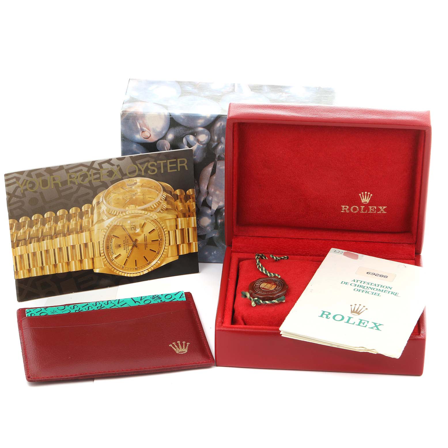 This image shows the packaging, booklet, warranty card, and accessories for a Rolex President 69288 Women's Yellow Gold Green Dial 69288 Women's Yellow Gold Green Dial model watch.