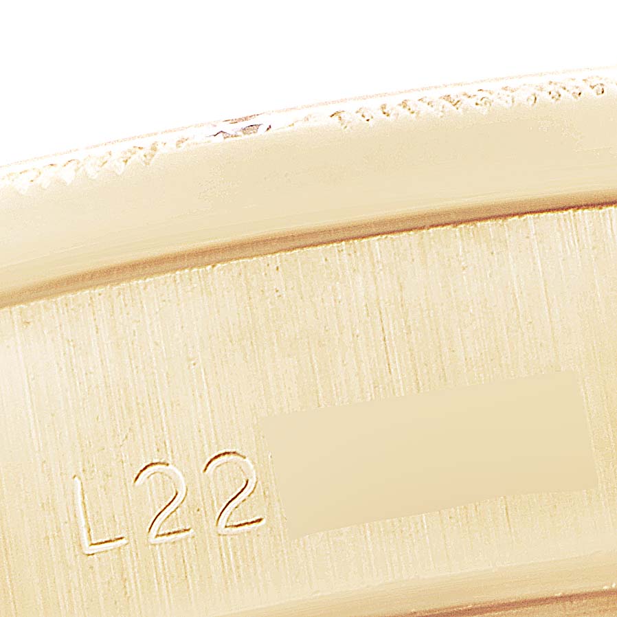 This image shows a close-up of the inner band of a Rolex President 69288 Women's Yellow Gold Green Dial 69288 Women's Yellow Gold Green Dial model watch, featuring engraved details.