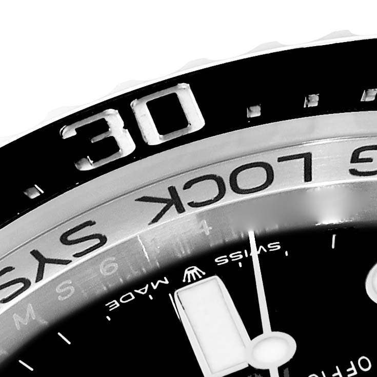 The image shows a close-up of the bezel and part of the dial of the Rolex Sea-Dweller 136660 Men's Stainless Steel Blue Dial 136660 Men's Stainless Steel Blue Dial watch.