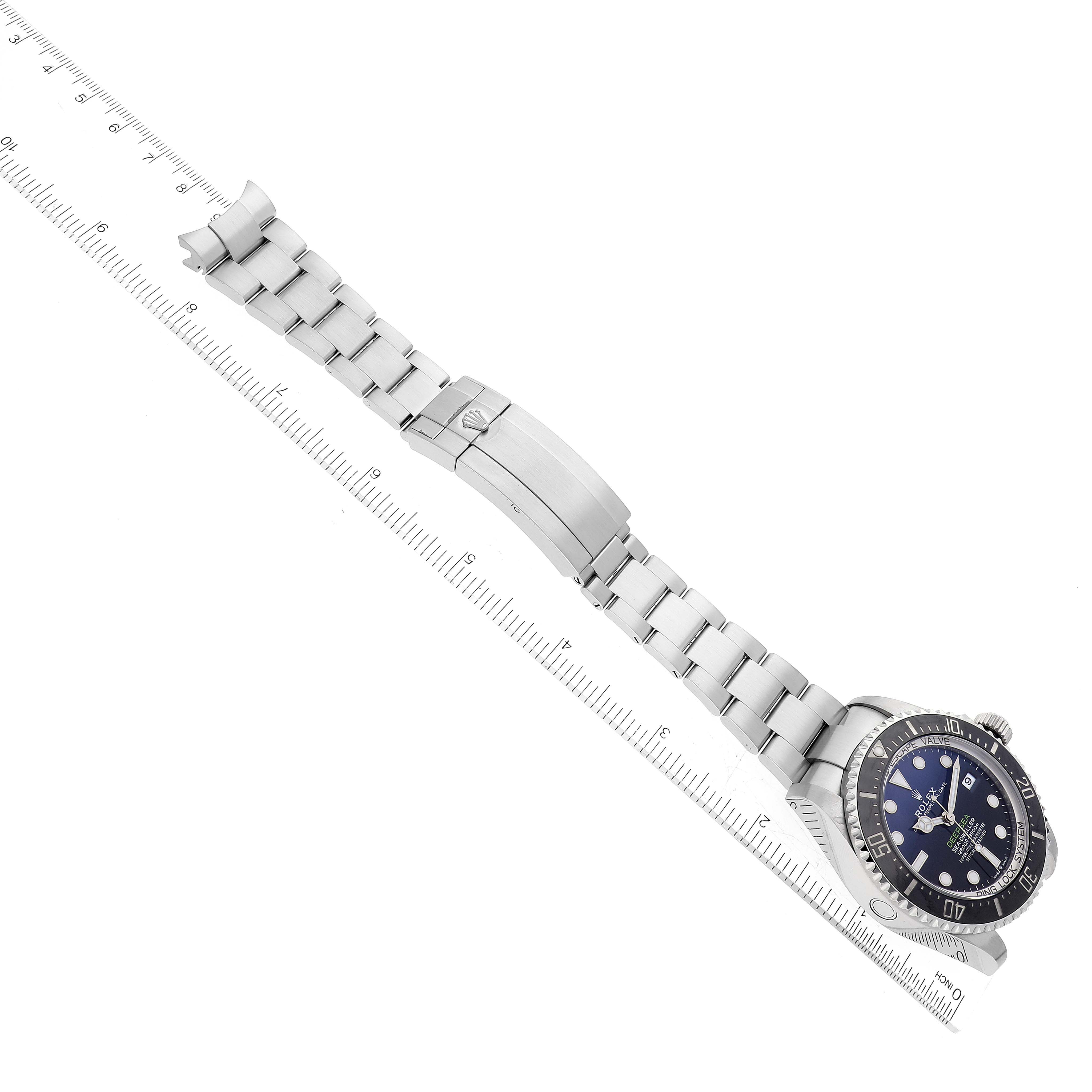 The image shows a top view of a Rolex Sea-Dweller 136660 Men's Stainless Steel Blue Dial 136660 Men's Stainless Steel Blue Dial watch and bracelet including the clasp and links, angled with a ruler for measurement.