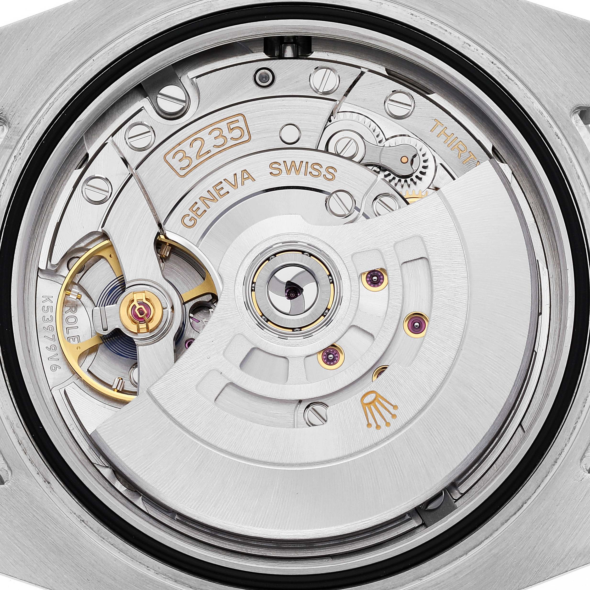 This image shows a close-up view of the intricate movement mechanism of a Rolex Submariner 126613 Men's Steel and Gold (two tone) Black Dial 126613 Men's Steel and Gold (two tone) Black Dial watch.