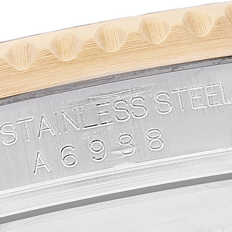 The image shows a close-up of the bezel and engraved serial number on a Rolex Submariner 16613 Men's Steel and Gold (two tone) Black Dial 16613 Men's Steel and Gold (two tone) Black Dial watch, featuring stainless steel and gold materials.