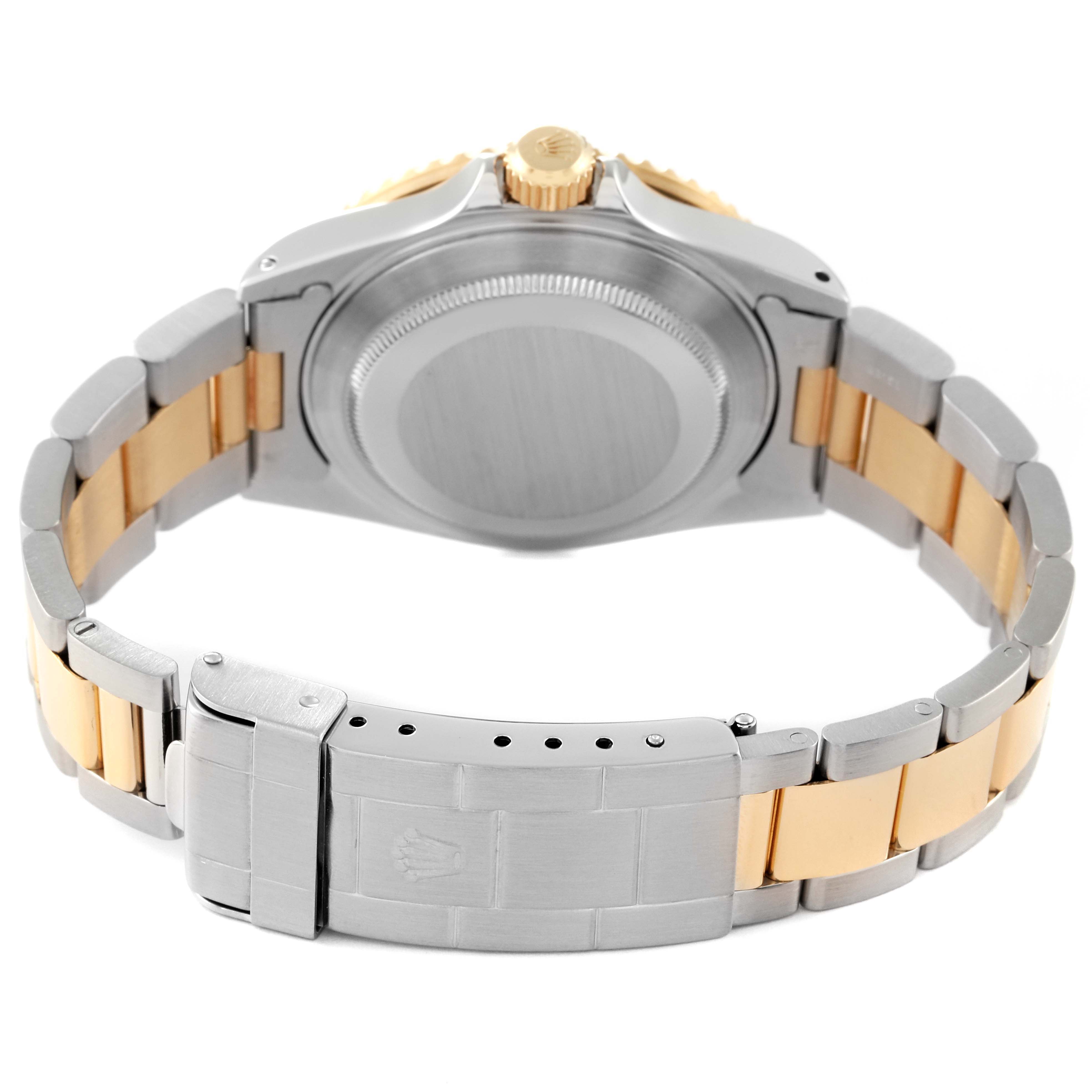 The image shows the back view of a Rolex Submariner 16613 Men's Steel and Gold (two tone) Black Dial 16613 Men's Steel and Gold (two tone) Black Dial watch, highlighting its two-tone bracelet and clasp.