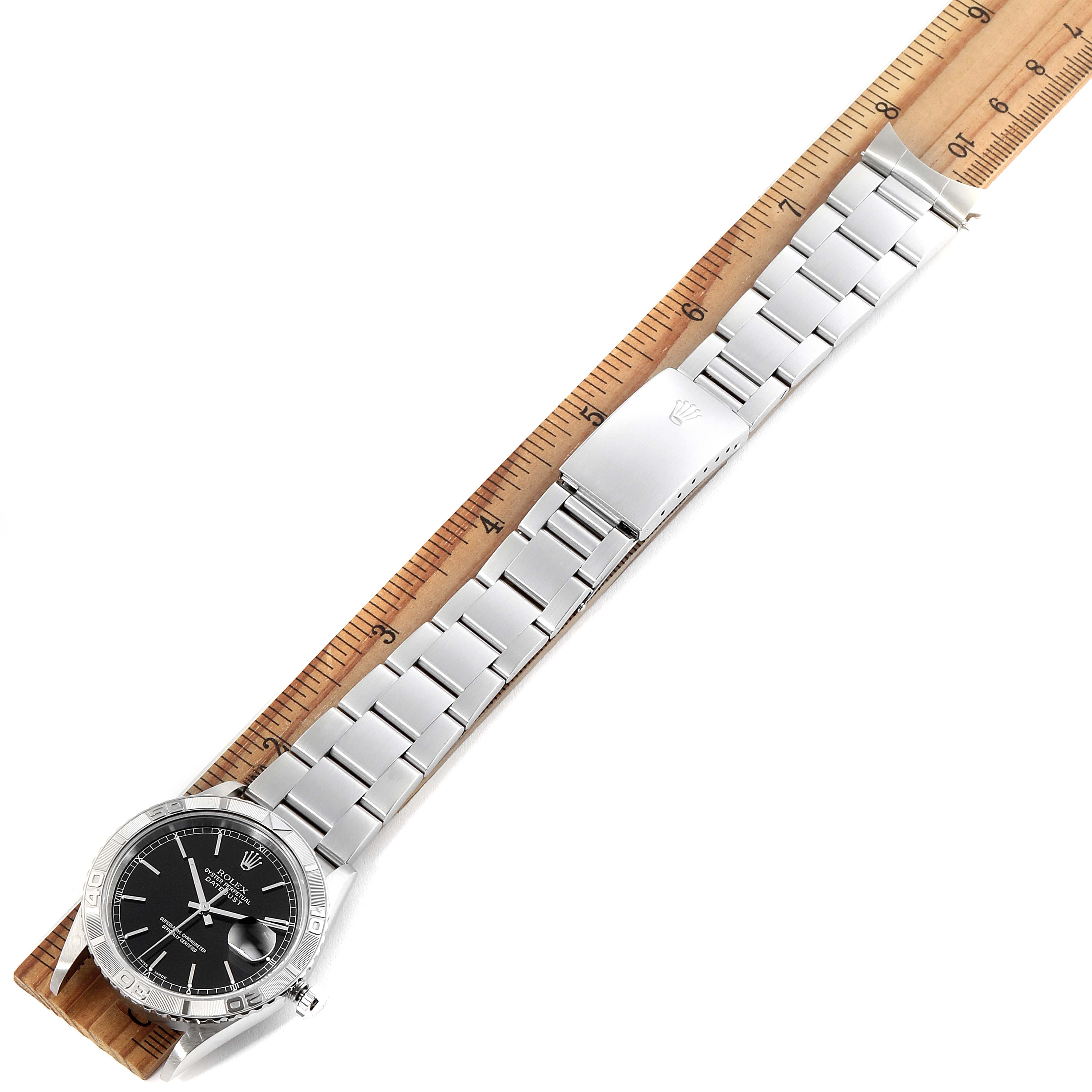 The image shows a Rolex Turn-o-Graph 16264 Men's Stainless Steel Black Dial 16264 Men's Stainless Steel Black Dial watch laid flat next to a ruler, clearly displaying its full bracelet and clasp.