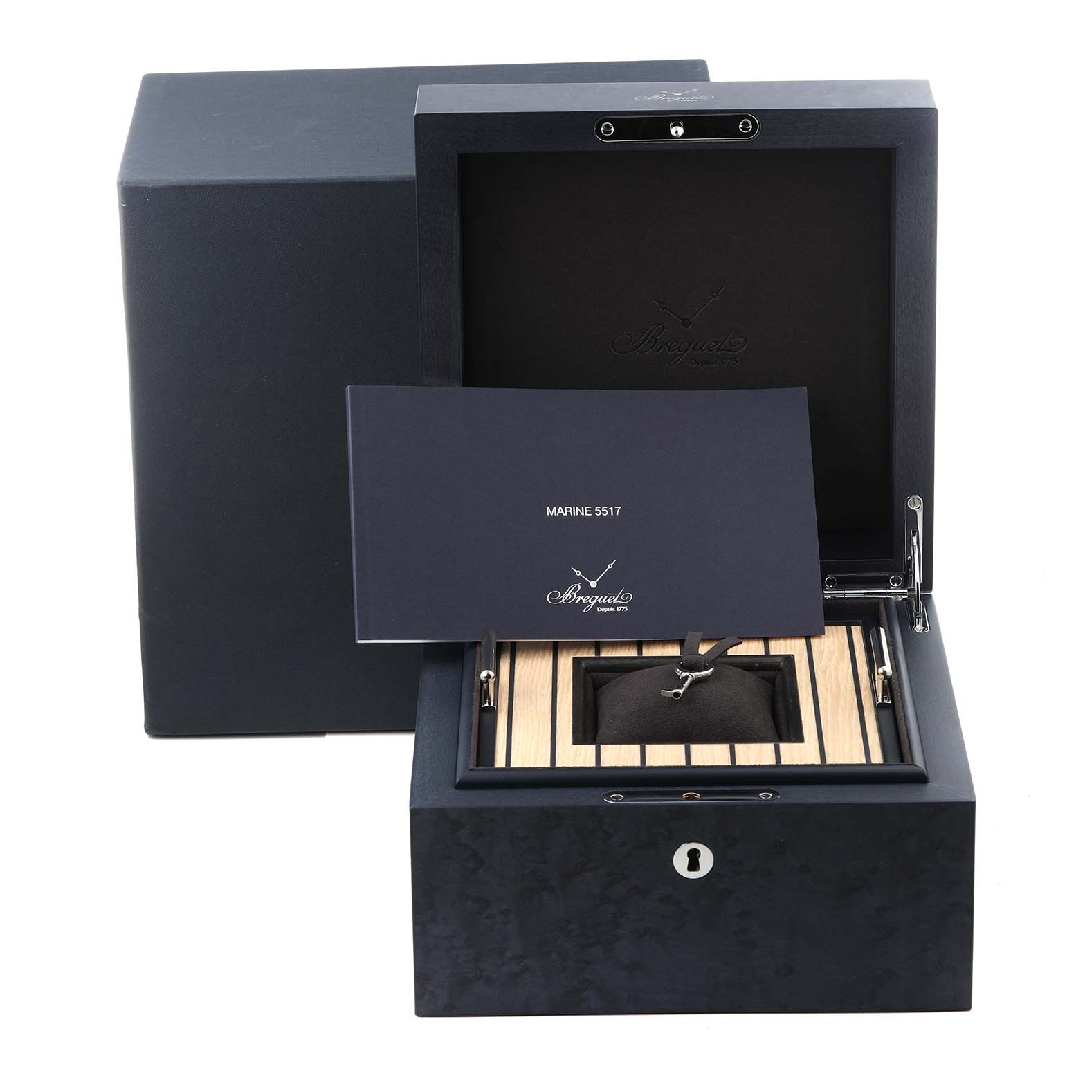 The image shows a Breguet Marine 5517TI/Y1/TZ0 Men's Titanium Blue Dial 5517TI/Y1/TZ0 Men's Titanium Blue Dial watch box, open with a booklet and a cushion inside.