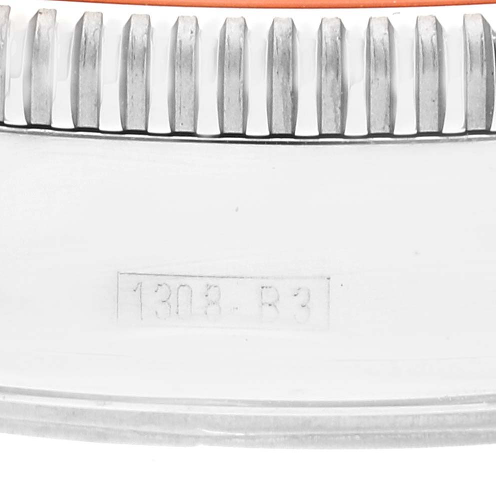 Close-up of the bezel and part of the case of a Breitling Superocean A13320 Men's Stainless Steel Brown Dial A13320 Men's Stainless Steel Brown Dial watch, showing the model engraving.