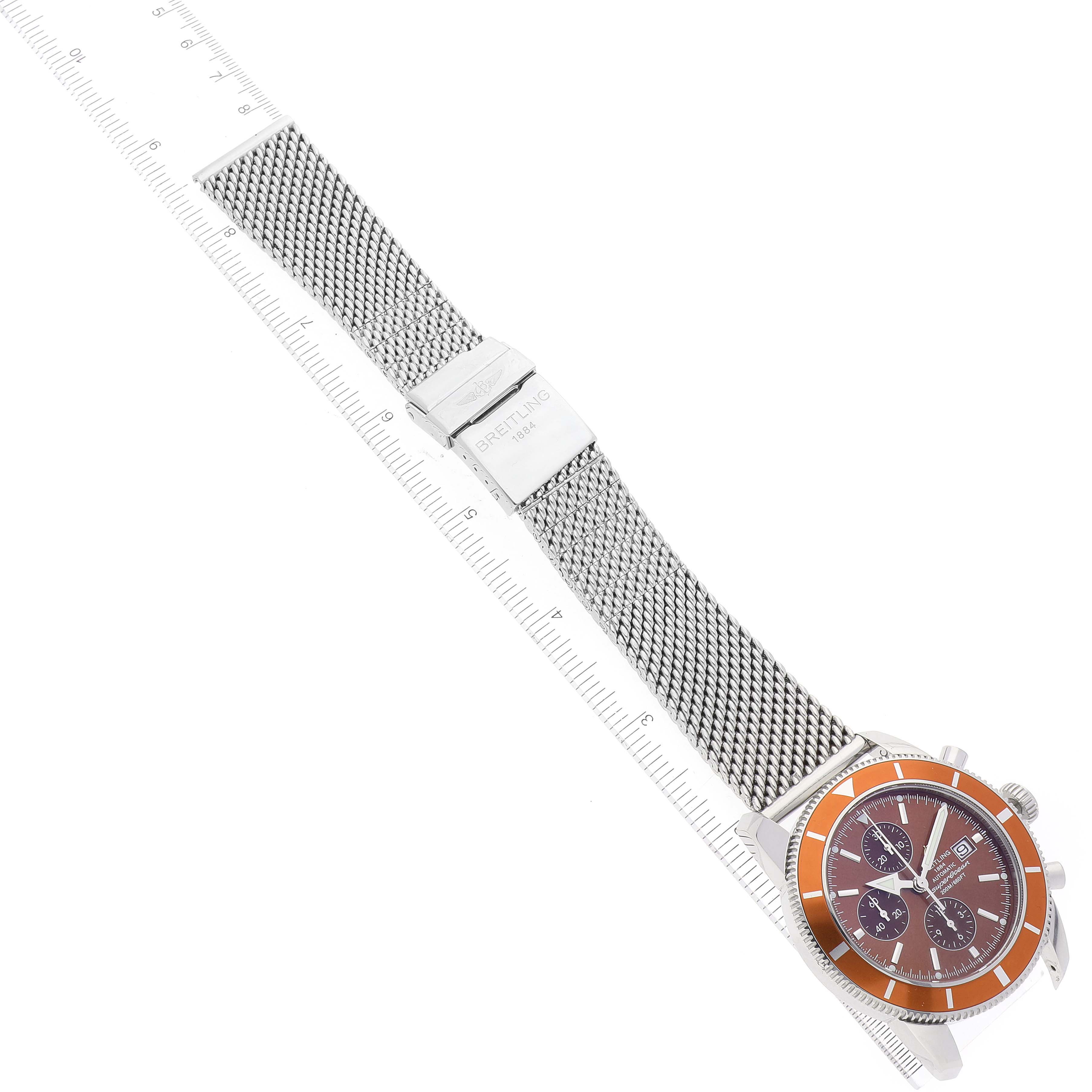 This image shows a top view of a Breitling Superocean A13320 Men's Stainless Steel Brown Dial A13320 Men's Stainless Steel Brown Dial watch, highlighting its mesh band and case with a visible clasp and orange bezel.