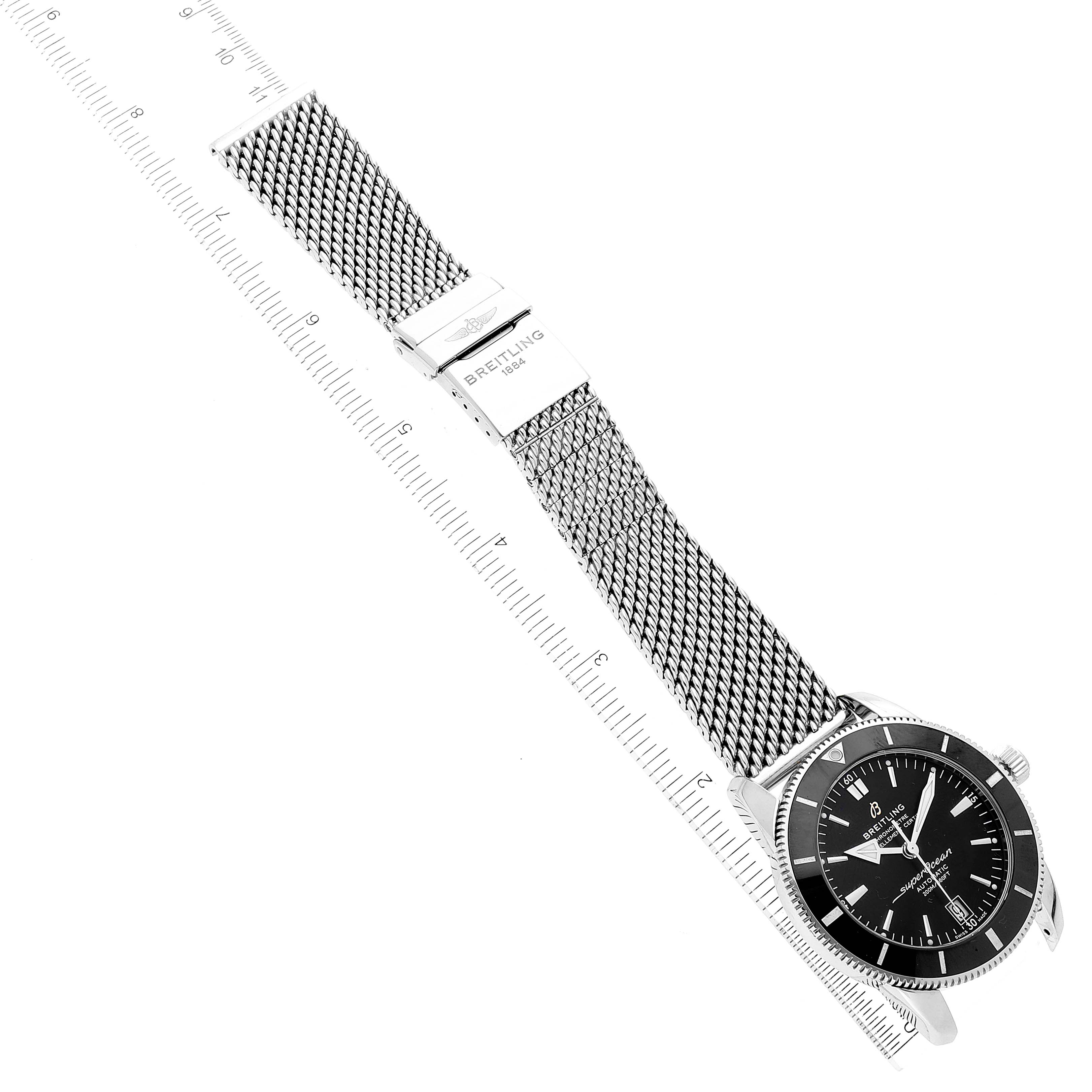 This image shows a Breitling Superocean AB2010161C1A1 Men's Stainless Steel Black Dial AB2010161C1A1 Men's Stainless Steel Black Dial watch from an overhead angle, displaying its face, bezel, mesh band, and clasp.