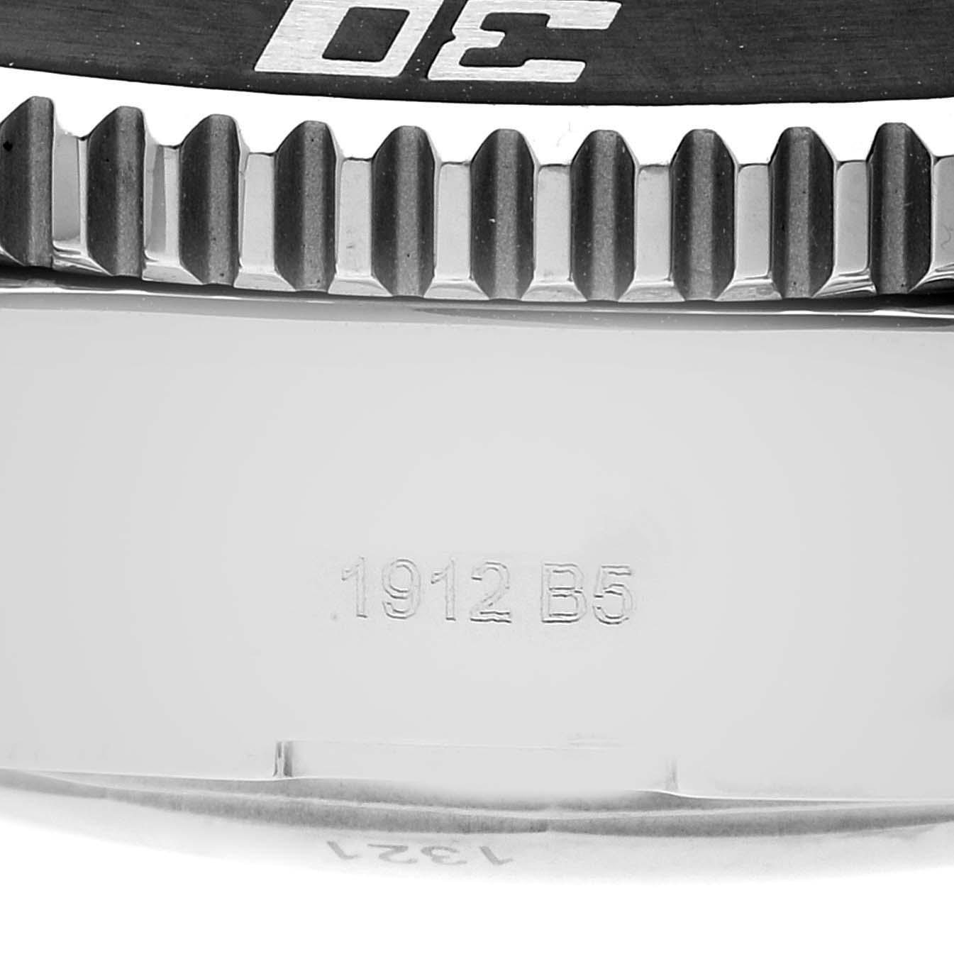 The image shows a close-up of the bezel and the engraved case back of a Breitling Superocean A73310 Men's Stainless Steel Black Dial A73310 Men's Stainless Steel Black Dial model watch.