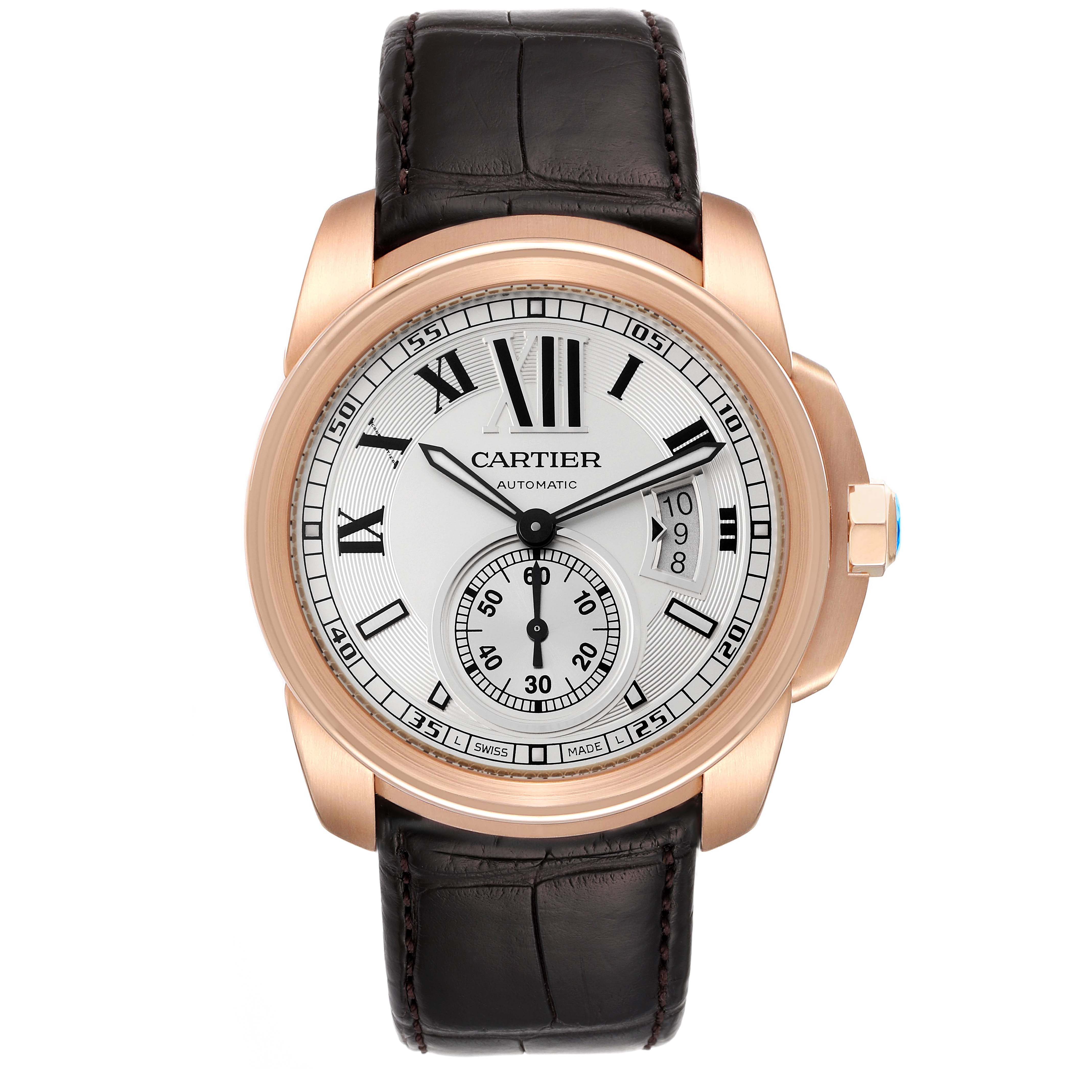 The image shows a front view of a Calibre de Cartier watch by Cartier, highlighting its dial, leather strap, and crown.