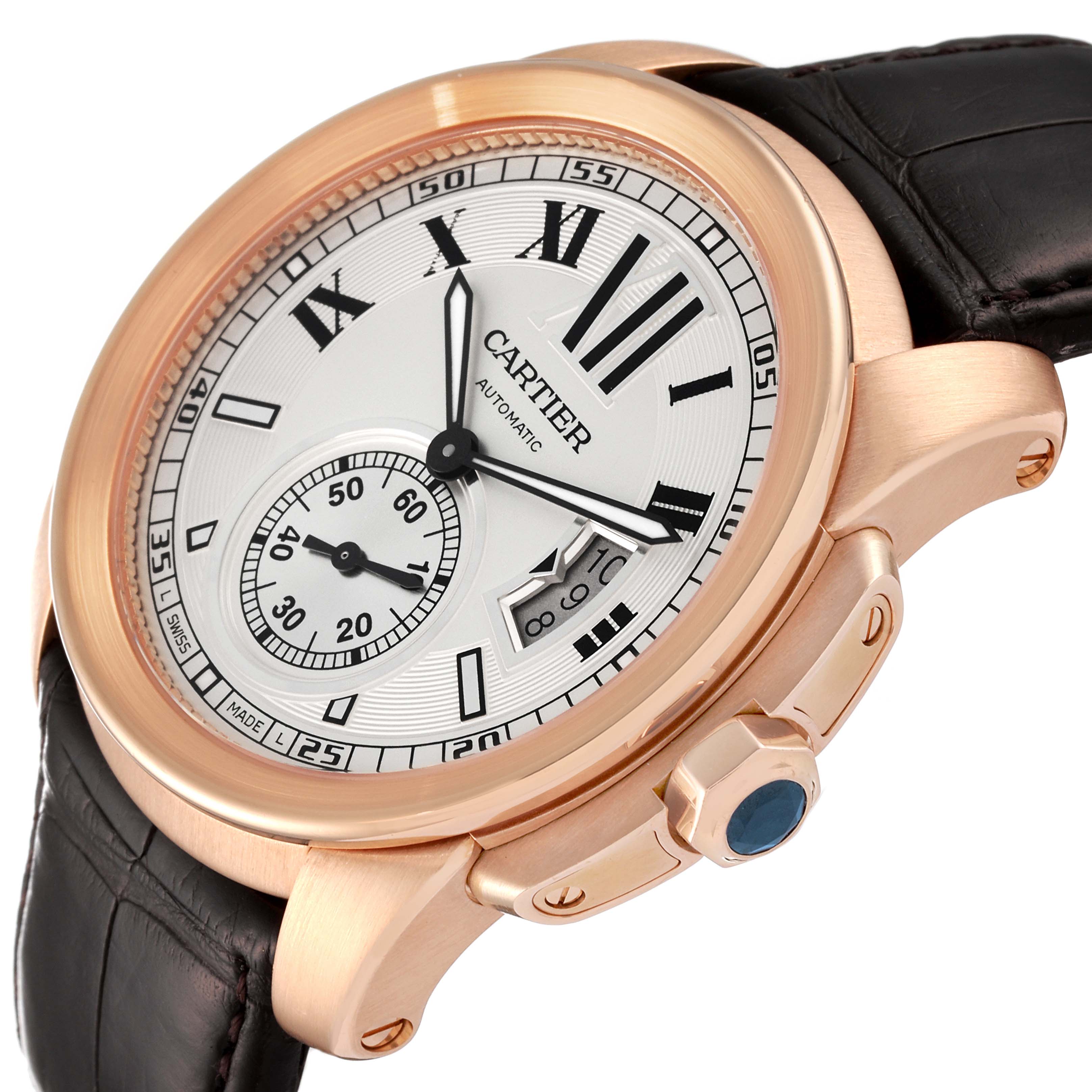 The image shows a Calibre de Cartier watch by Cartier from a slightly angled view, highlighting the dial, crown, and part of the strap.