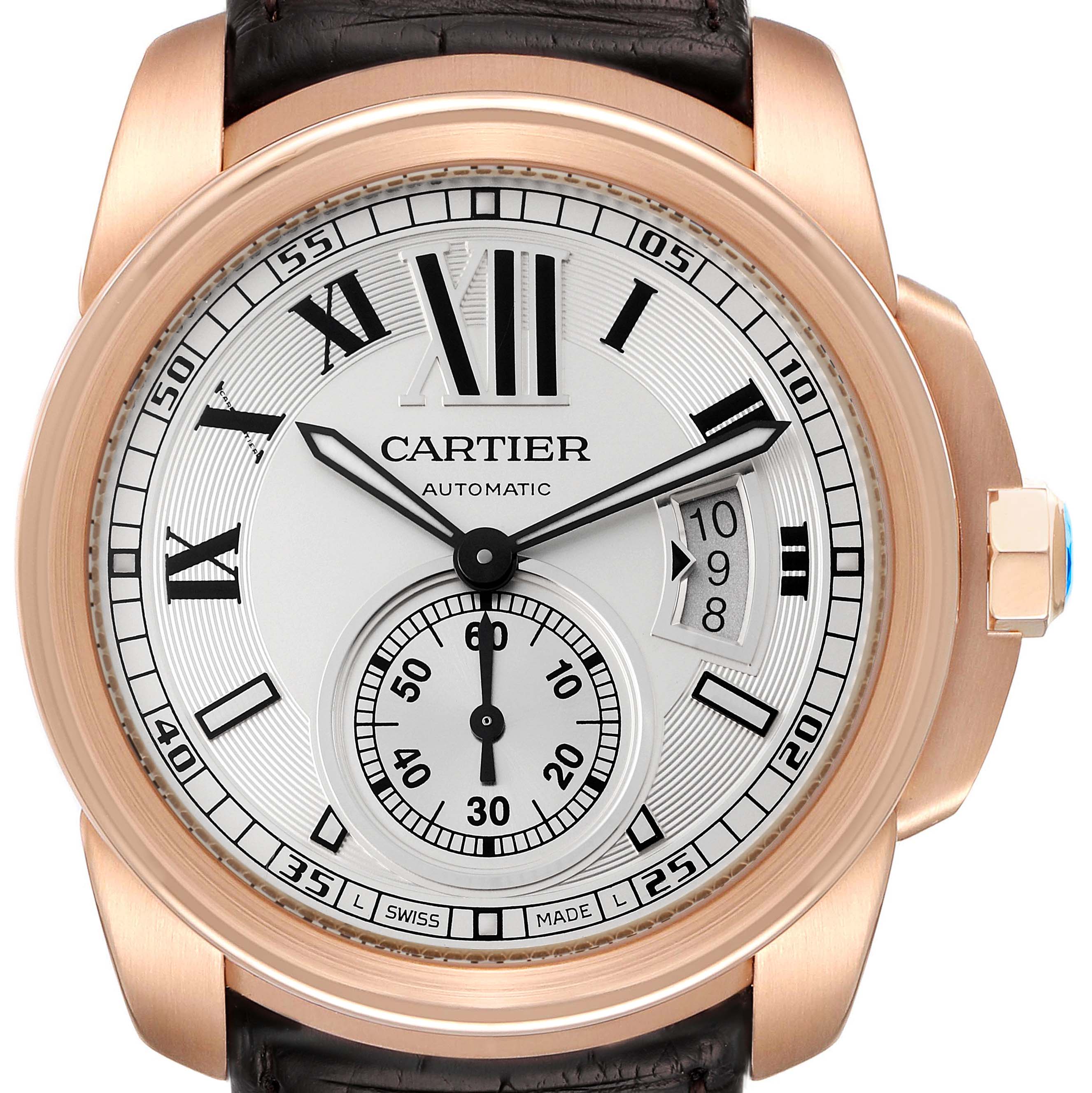 The Calibre de Cartier watch is shown from a front angle, highlighting the dial, hands, date display, and part of the leather strap.