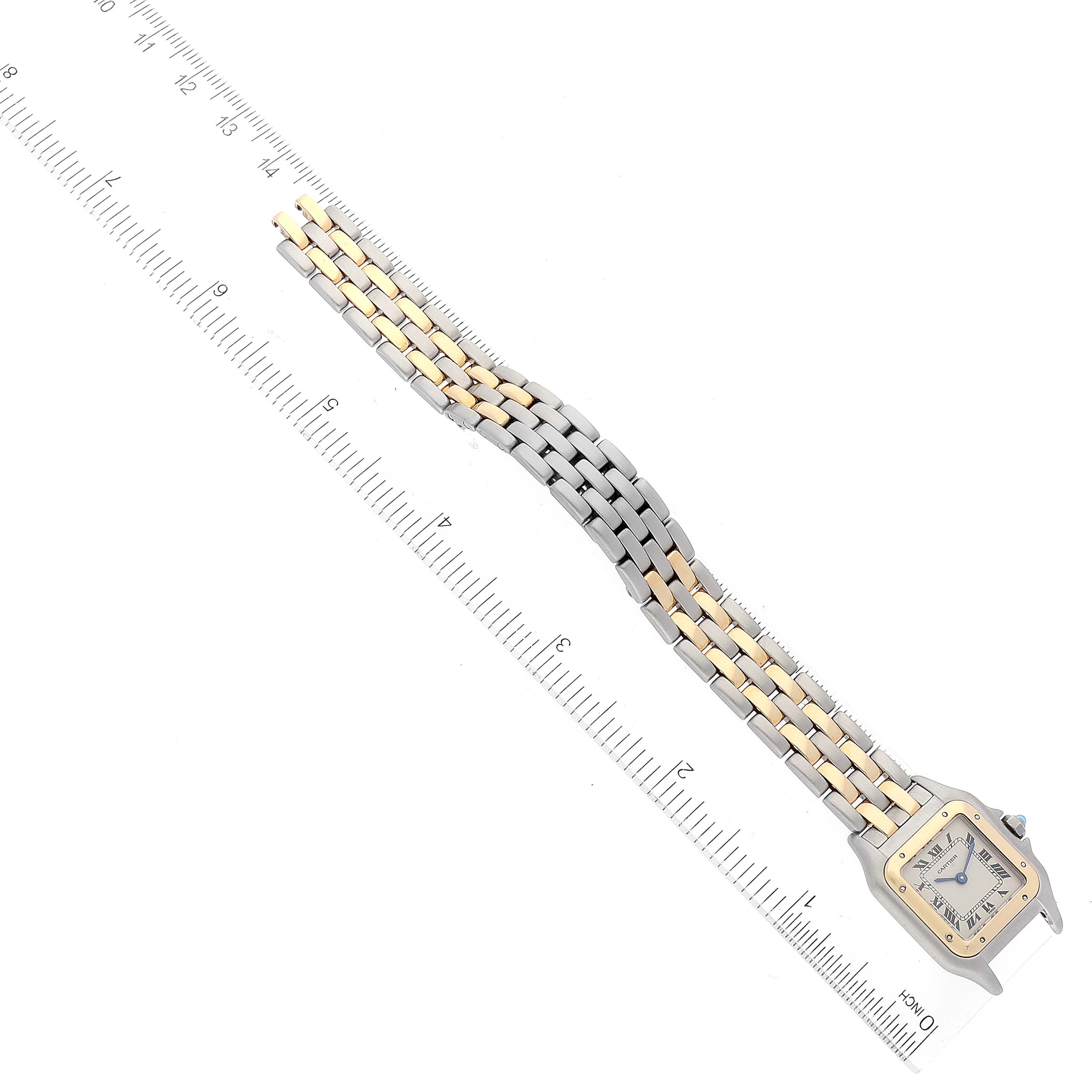 This image displays a Panthere model by Cartier watch laid flat, showcasing the watch face and bracelet alongside a ruler for measurement.