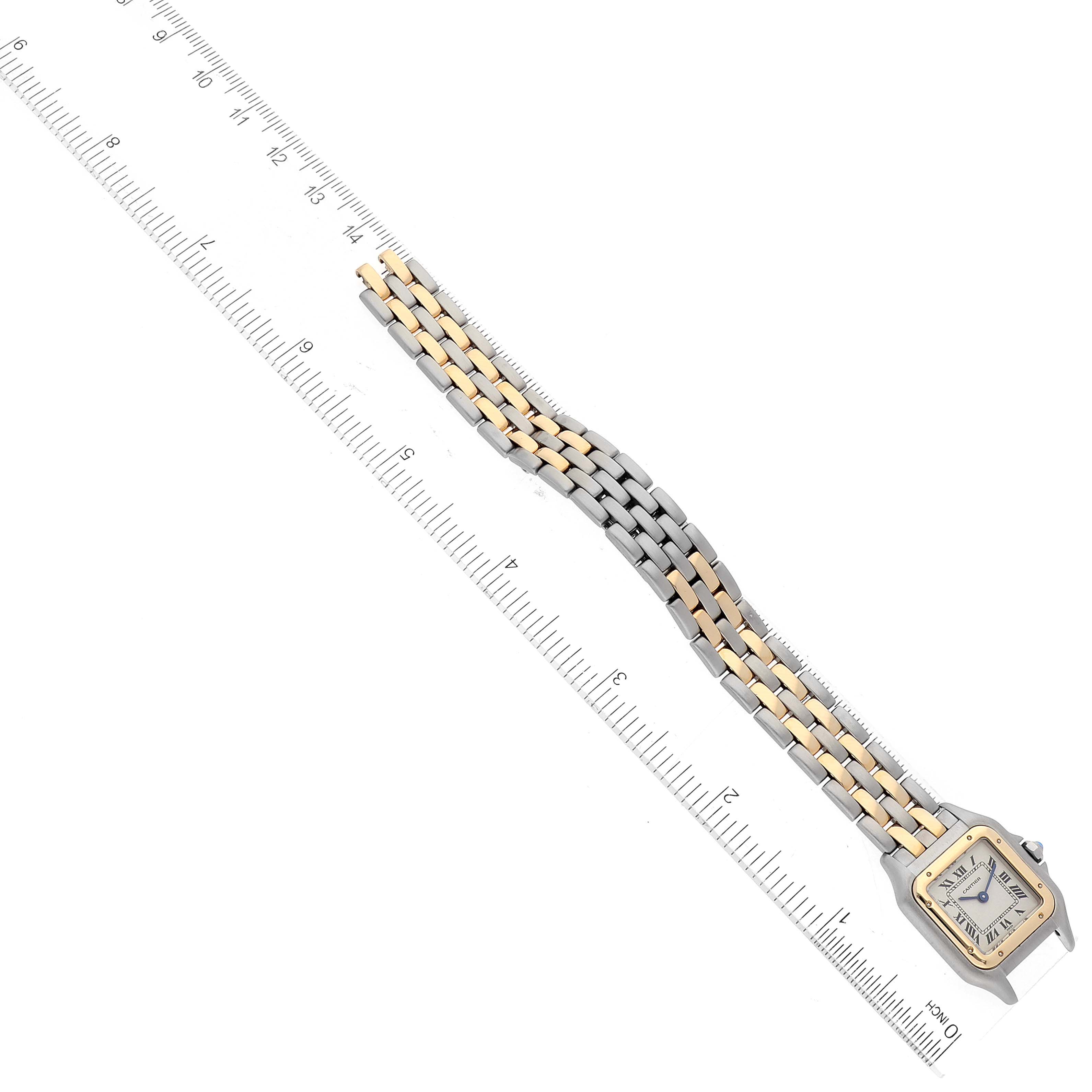 The image shows a Panthère de Cartier watch laid flat with a two-tone band next to a ruler, viewed from the top.
