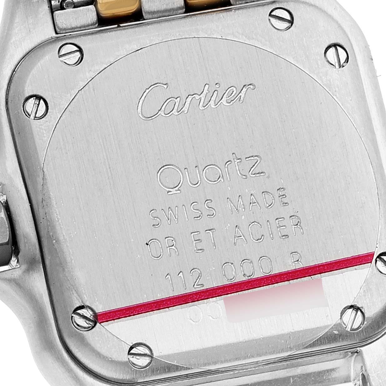 The image shows the back casing of a Cartier Panthere W25029B6 Women's Steel and Gold (two tone) Silver Dial W25029B6 Women's Steel and Gold (two tone) Silver Dial model watch, highlighting its screws and engraved text.