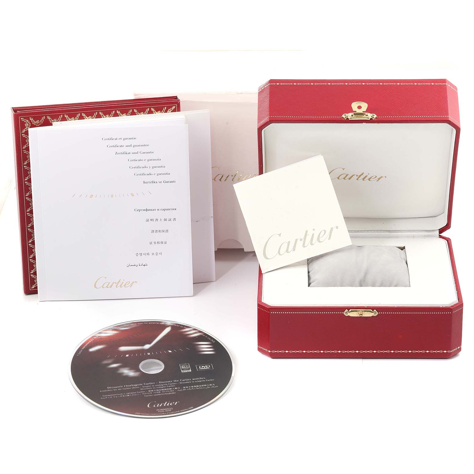 The image shows the packaging and accessories of a Cartier Pasha W31080M7 Men's Stainless Steel Silver Dial W31080M7 Men's Stainless Steel Silver Dial watch, including the box, manual, and a CD.