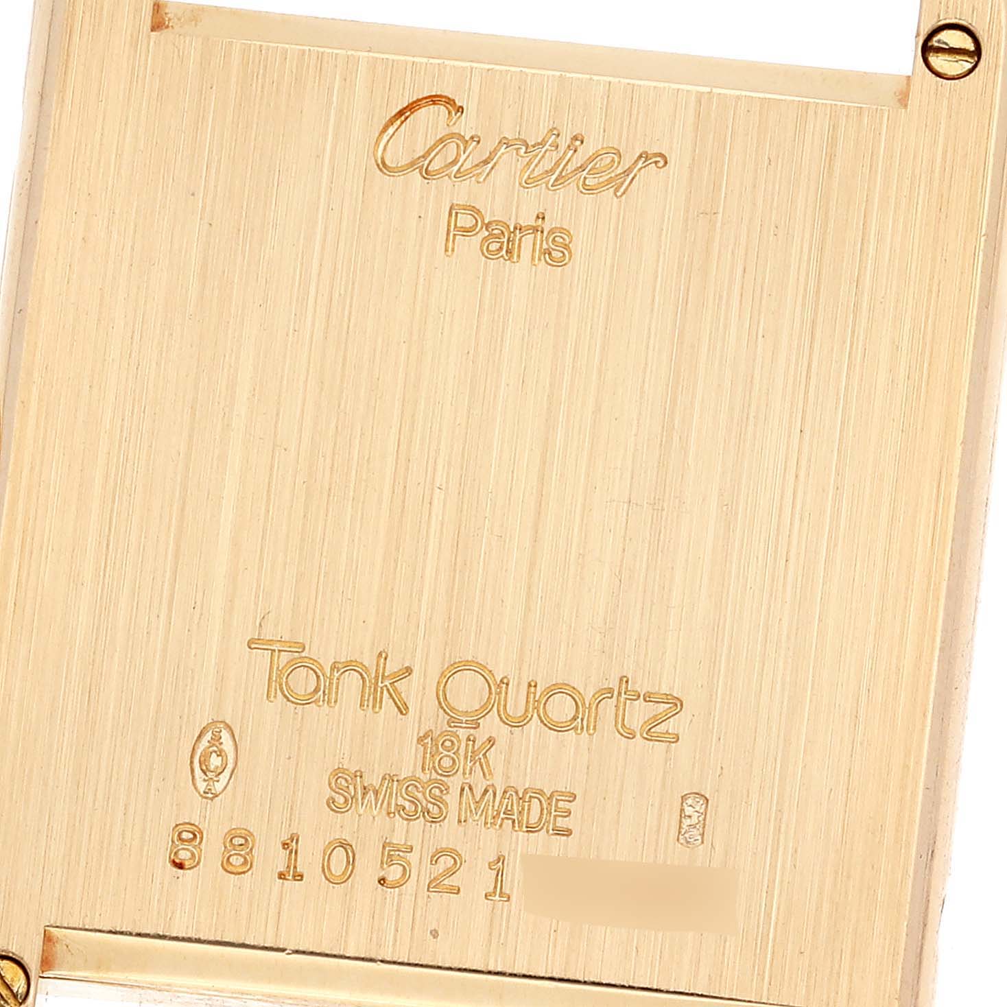 This is the back view of a Cartier Tank Classic Women's Yellow Gold White Dial Women's Yellow Gold White Dial watch, showing engravings including the model name, material, and serial number.