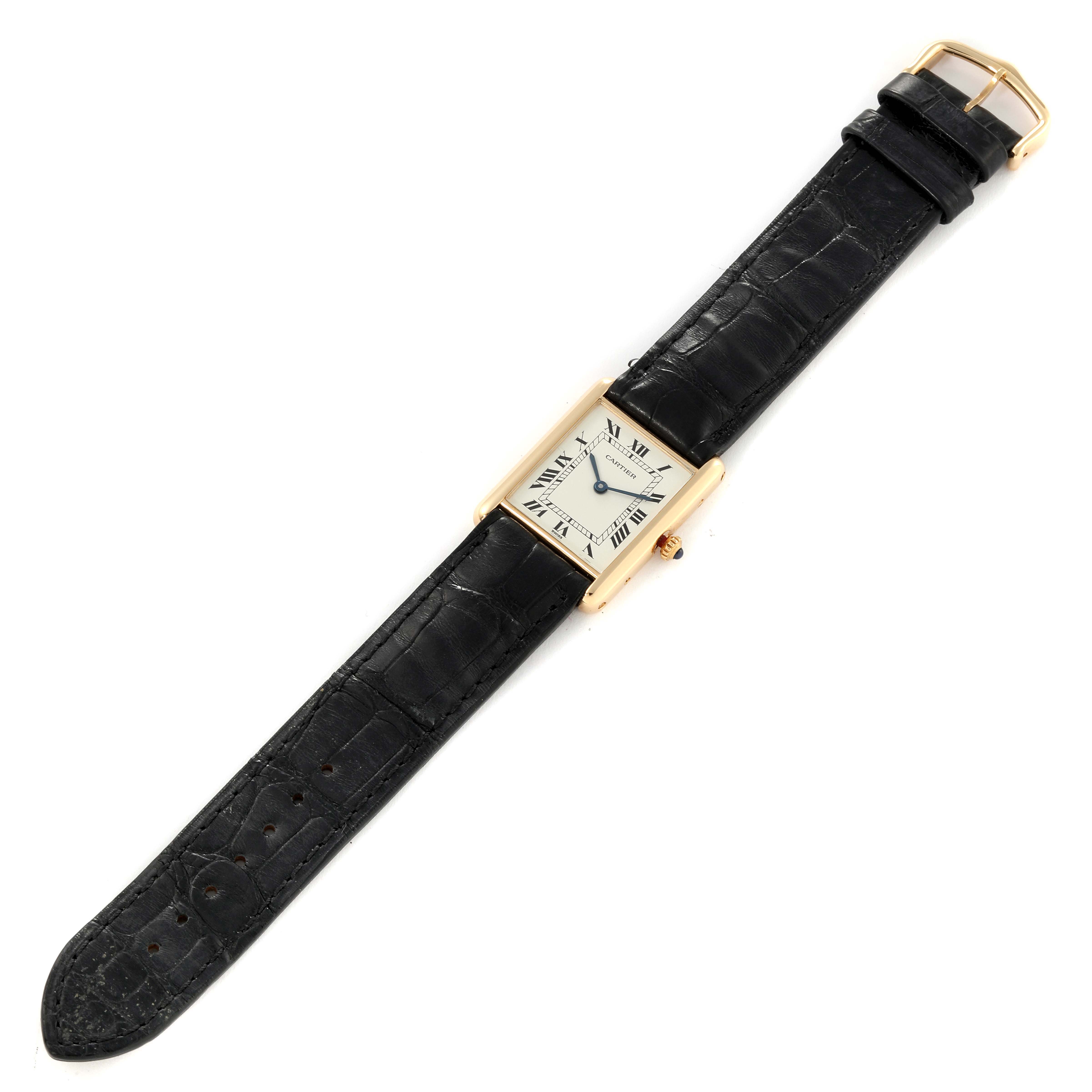 The image shows a Cartier Tank Classic Women's Yellow Gold White Dial Women's Yellow Gold White Dial watch at a top-down angle, displaying the face, case, and black leather strap.