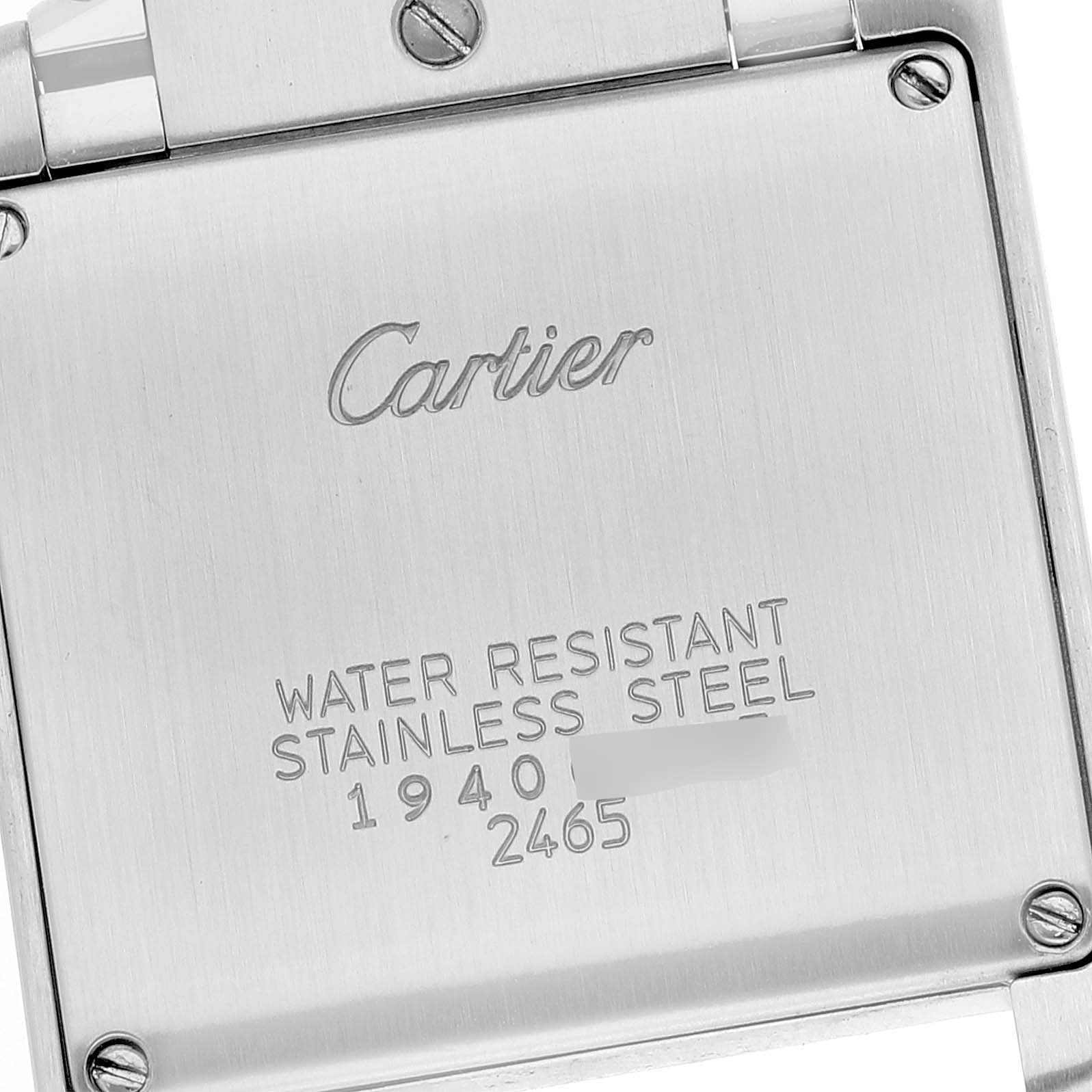 The image shows the back casing of a Cartier Tank Francaise W51011Q3 Women
s Stainless Steel Silver Dial W51011Q3 Women
s Stainless Steel Silver Dial watch, featuring engravings and screws.