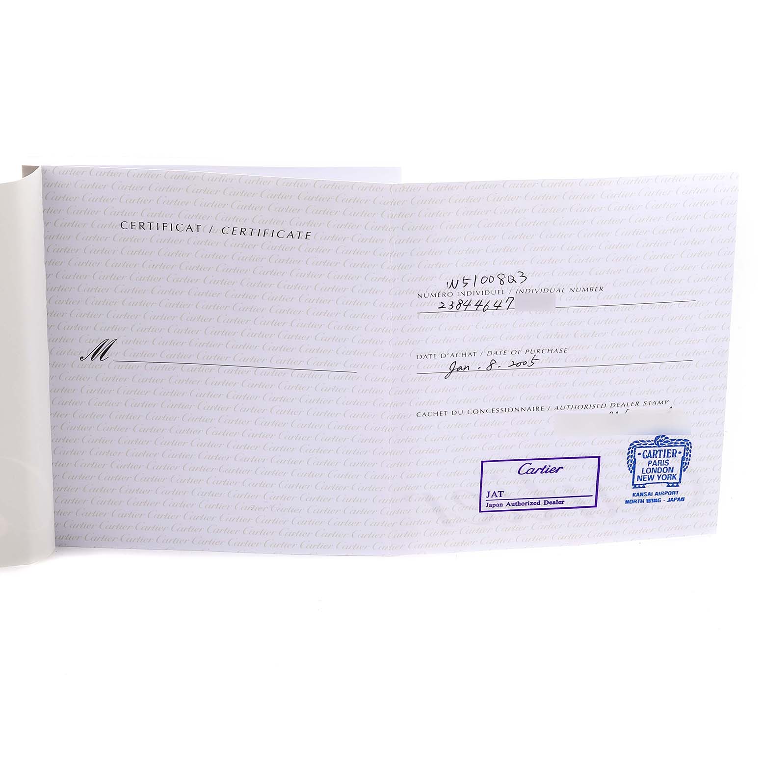 This image shows a certificate for a Tank Francaise model by Cartier at an angled view, displaying purchase details and dealer stamps.