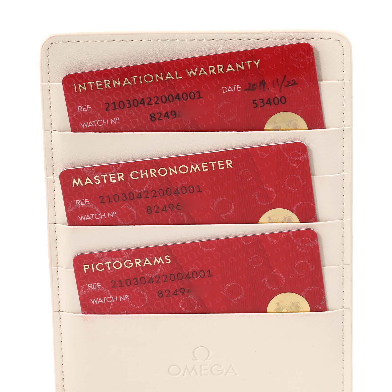 The image shows three card slots containing warranty and certification cards for the Omega Seamaster 210.30.42.20.04.001 Men's Stainless Steel White Dial 210.30.42.20.04.001 Men's Stainless Steel White Dial watch.