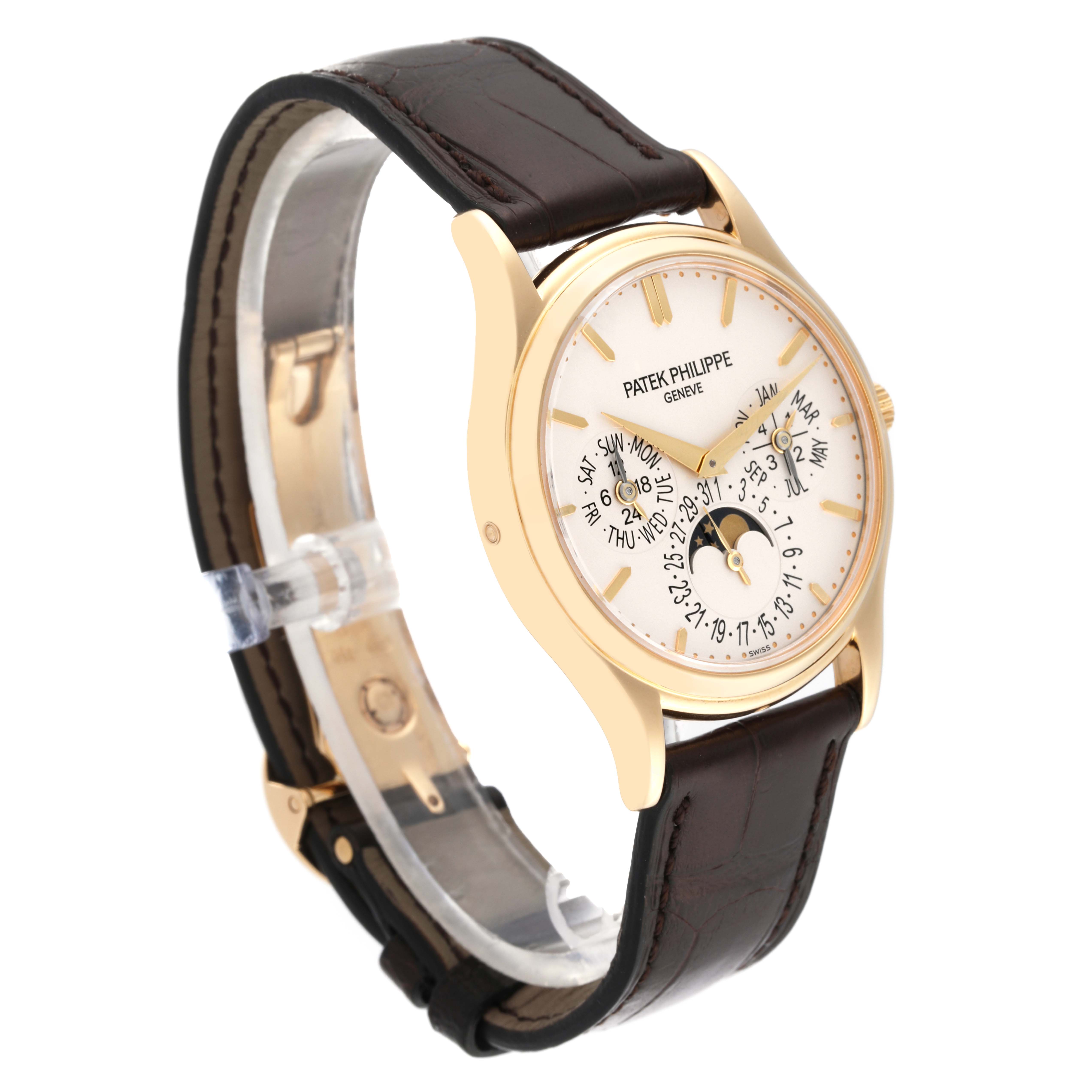 The Patek Philippe Calatrava 5140J-001 Men
s Yellow Gold Silver Dial 5140J-001 Men
s Yellow Gold Silver Dial watch is shown at an angle, displaying its dial, bezel, and brown leather strap.