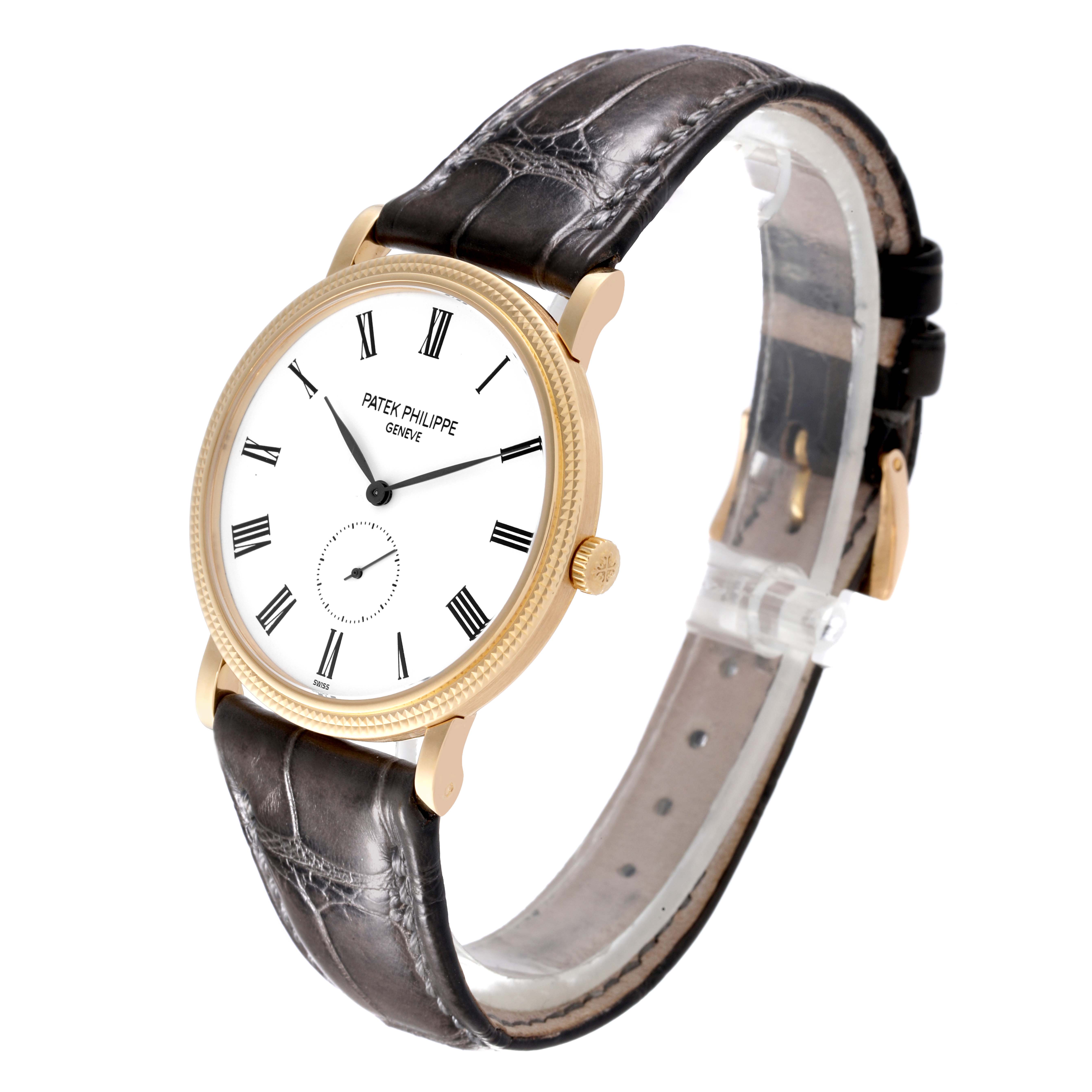 The Patek Philippe Calatrava 5119J Men's Yellow Gold White Dial 5119J Men's Yellow Gold White Dial watch is shown at a side angle, highlighting the face, bezel, crown, and leather strap.