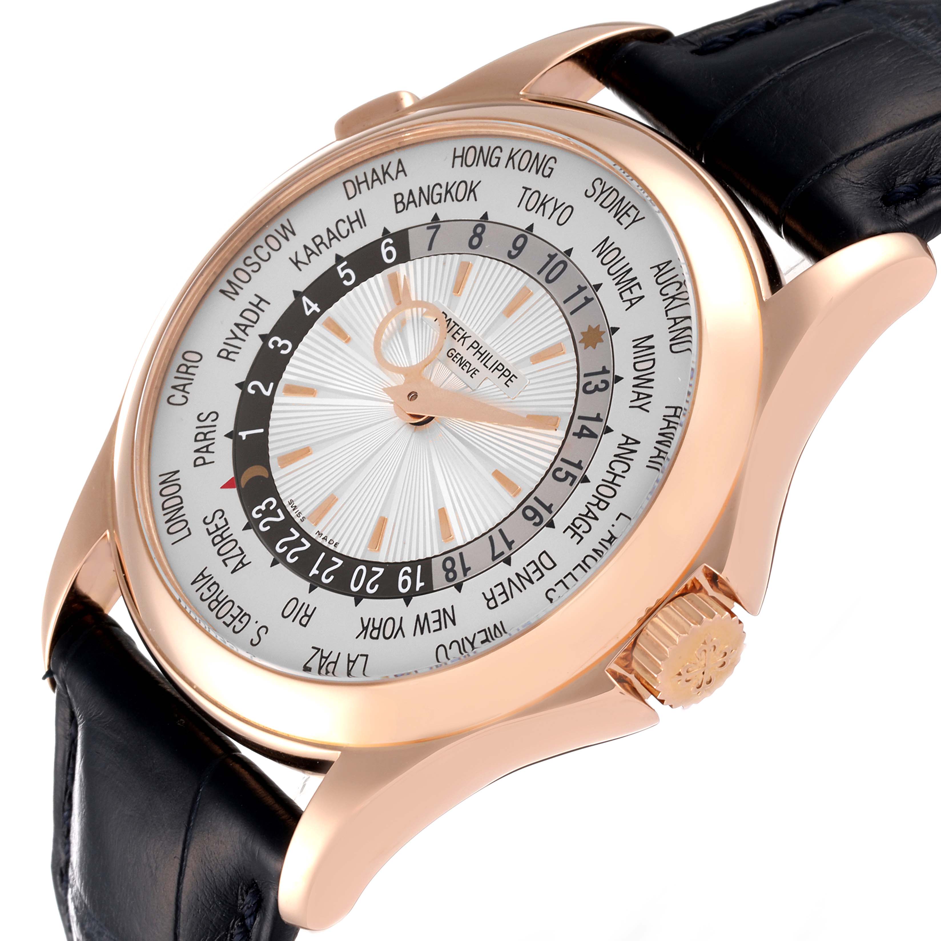 This image shows a Patek Philippe Complications 5130R Men's Rose Gold Silver Dial 5130R Men's Rose Gold Silver Dial model watch at an angled view, highlighting its dial, crown, and world time display.