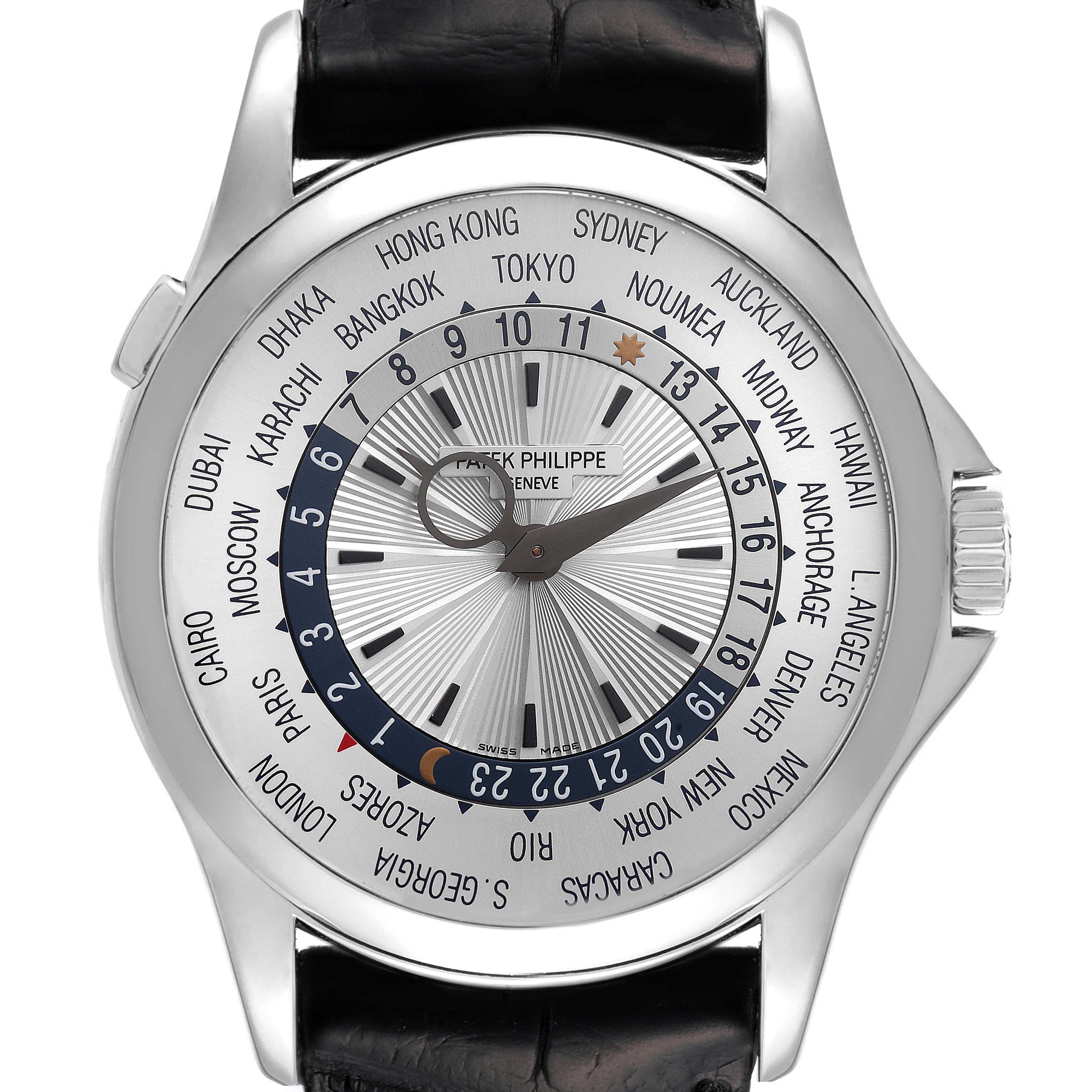 The image shows a front-angle view of the Patek Philippe Complications 5130G-019 Men's White Gold Silver Dial 5130G-019 Men's White Gold Silver Dial model, highlighting its world time function and leather strap.