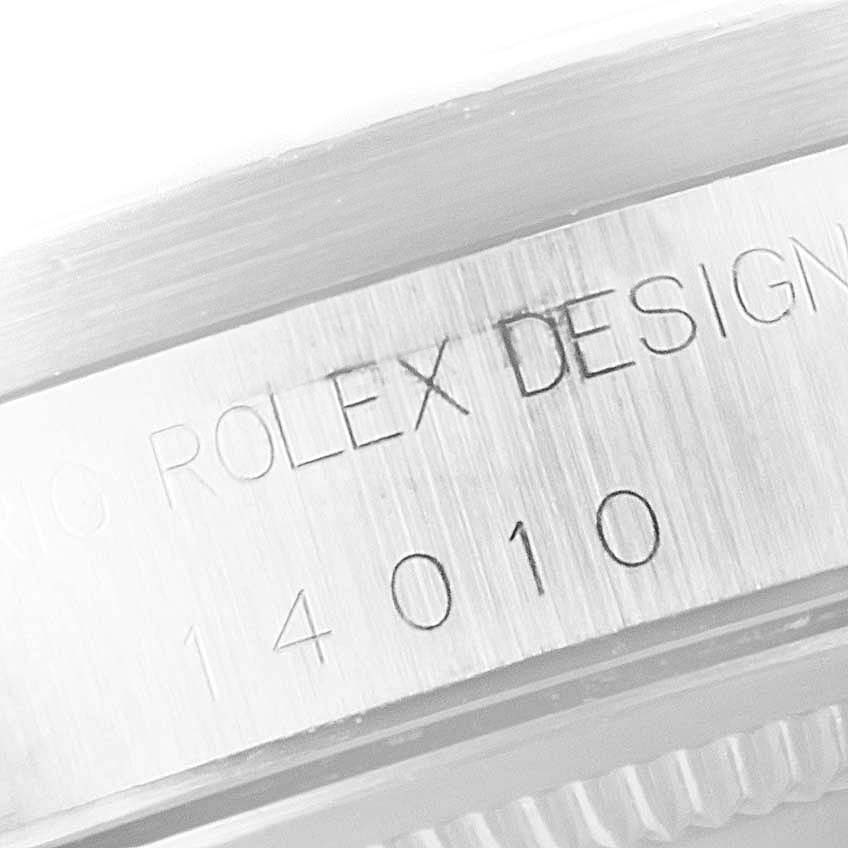 The image shows a close-up of the case side of a Rolex Air-King 14010 Men's Stainless Steel White Dial 14010 Men's Stainless Steel White Dial watch, displaying the model number and "Rolex Design" engraving.