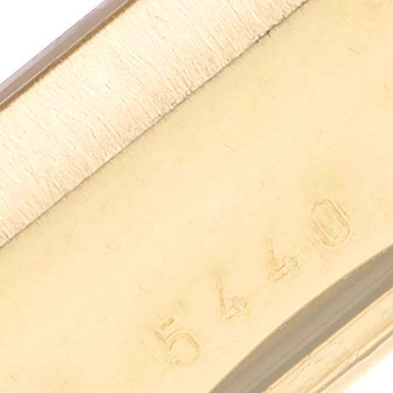 This image shows a close-up of a part of a Rolex Cellini 5440/8 Men
s Yellow Gold Champagne Dial 5440/8 Men
s Yellow Gold Champagne Dial watch, featuring the edge and serial number.